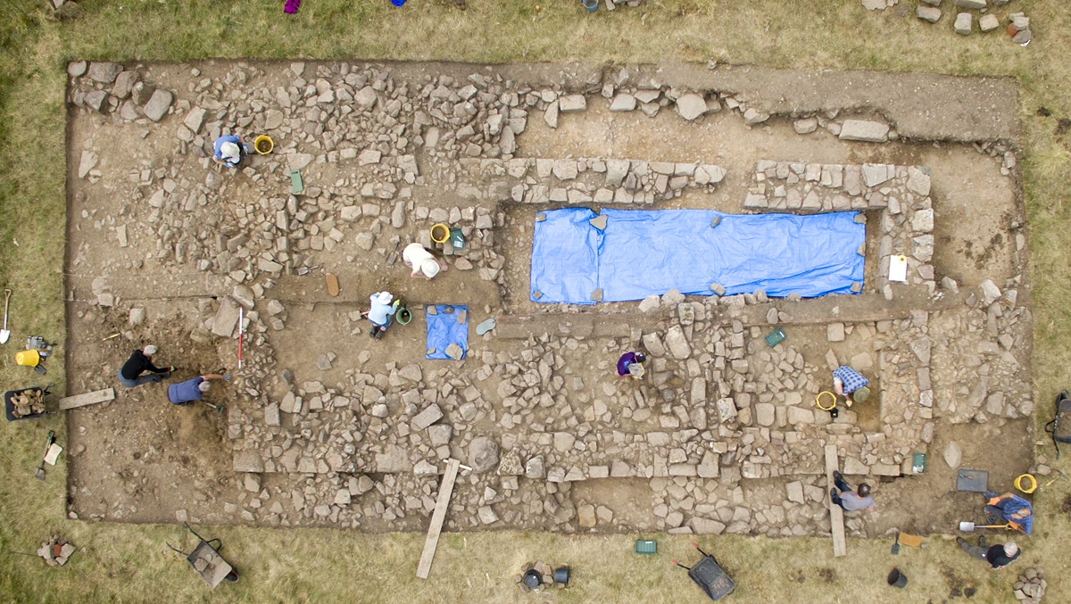 Coquetdale Community Archaeology volunteers working on the exposed remains of a medieval farmhouse at Linbrig near Alwinton in the north of Northumberland National Park. 