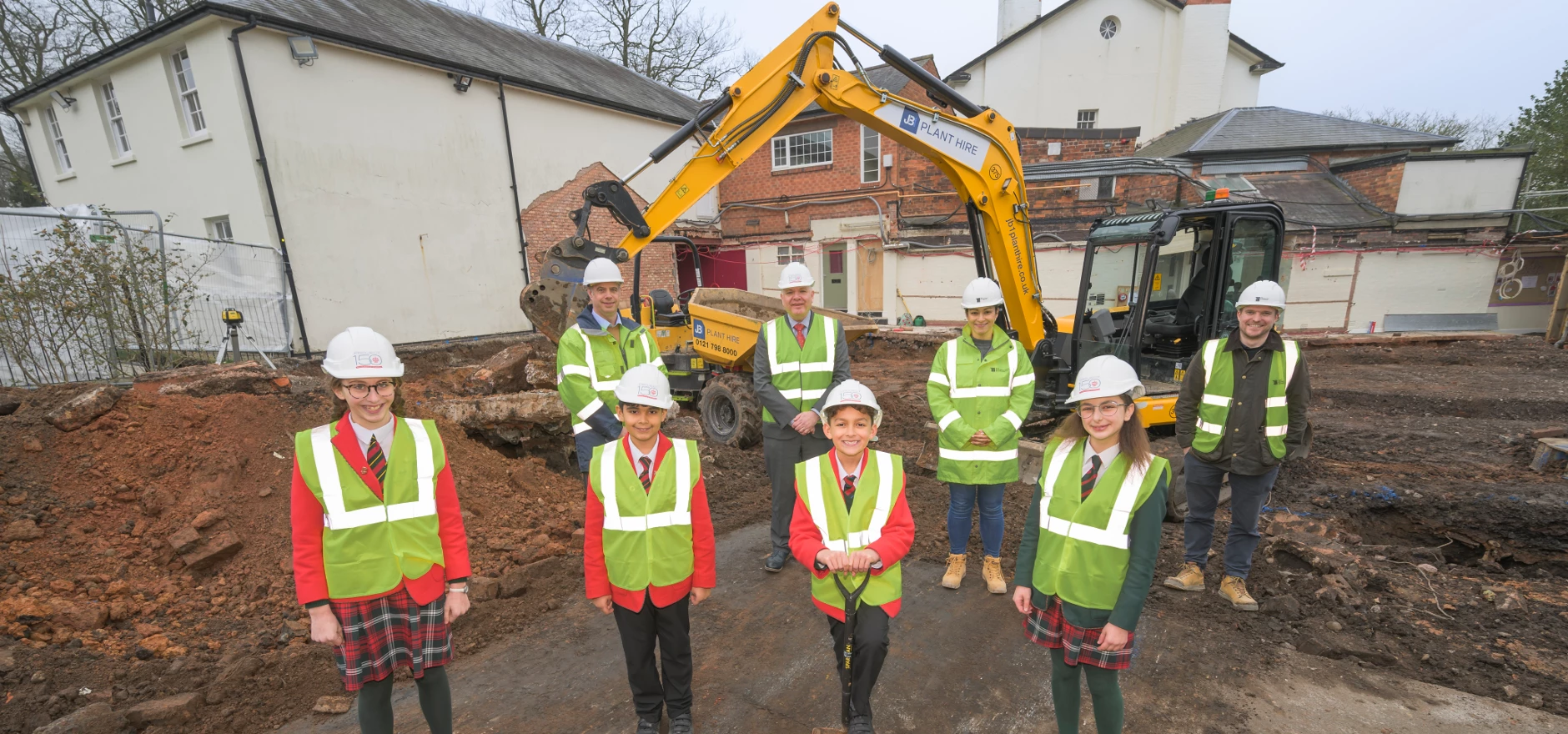 Front row, from left: Hallfield School pupils Lucilla, Dhyan, Rocco, and Angie. Back row from left: Andrew Higham, Construction Manager at The Wigley Group, Keith Morrow, Headmaster of Hallfield School, Sabrina Sharpe, Quantity Surveyor at The Construction Consultants, and Aaron Murphy, Director of The Construction Consultants.