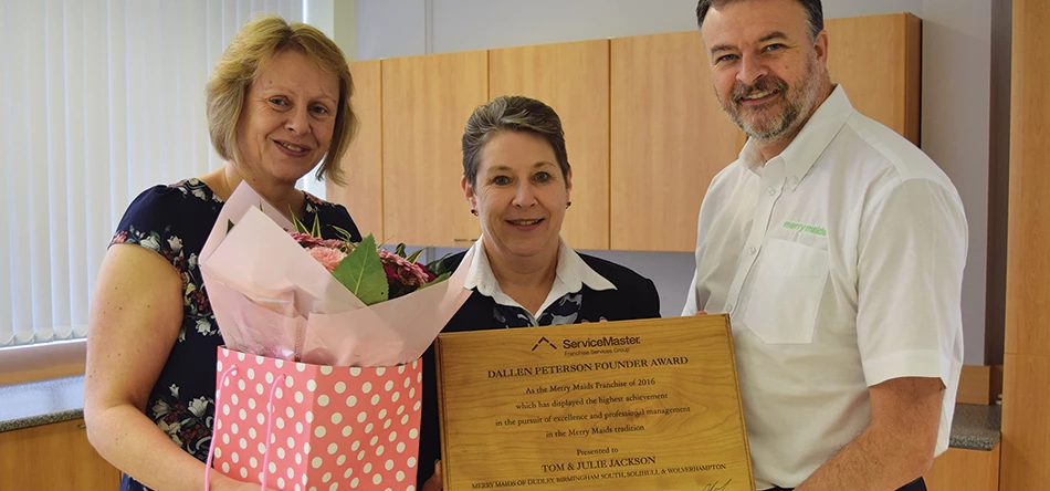 Julie (L) and Tom Jackson (Right) celebrate their award with Merry Maids brand operations manager, Cat Berry (Centre).