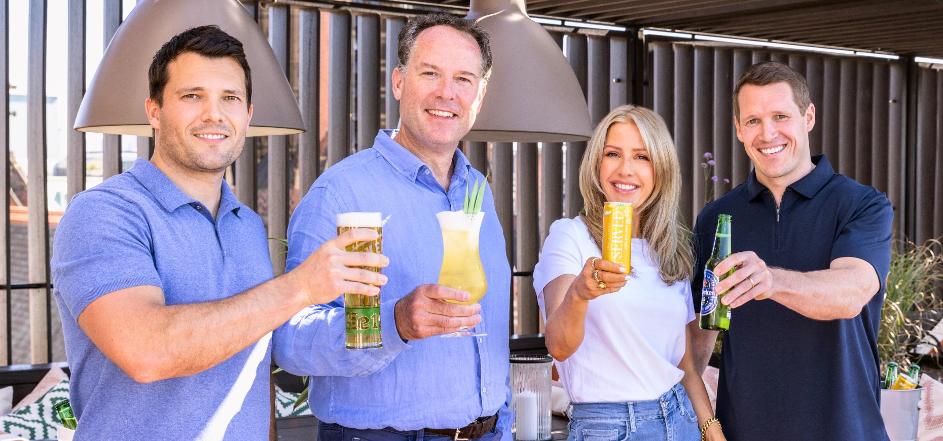 Ellie Goulding and representatives from Heineken UK and Served holding drinks.