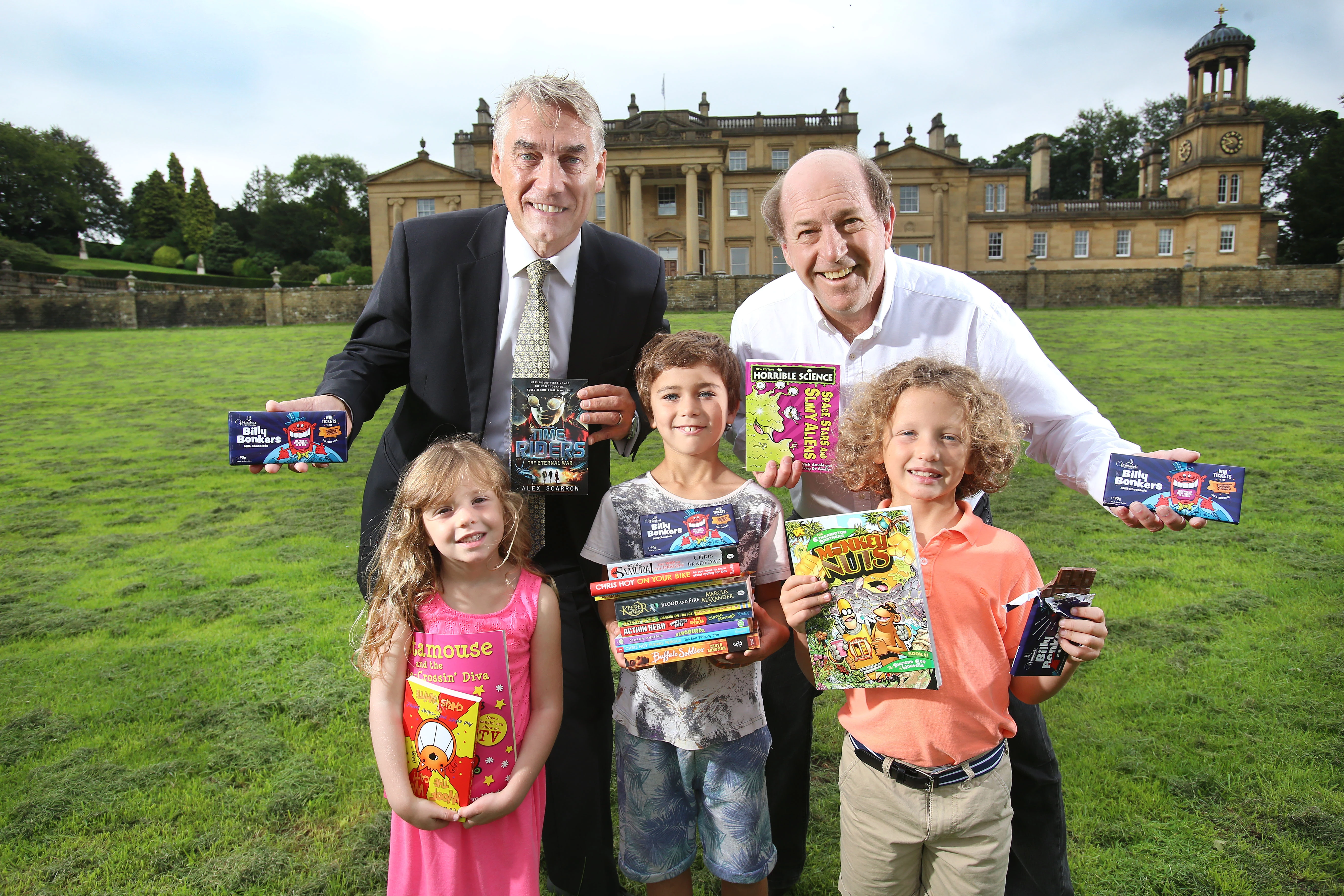 William Whitaker, managing director of Whitakers Chocolates and Trevor Wilson from the Broughton Hall Children's Literature Festival with young book lovers 