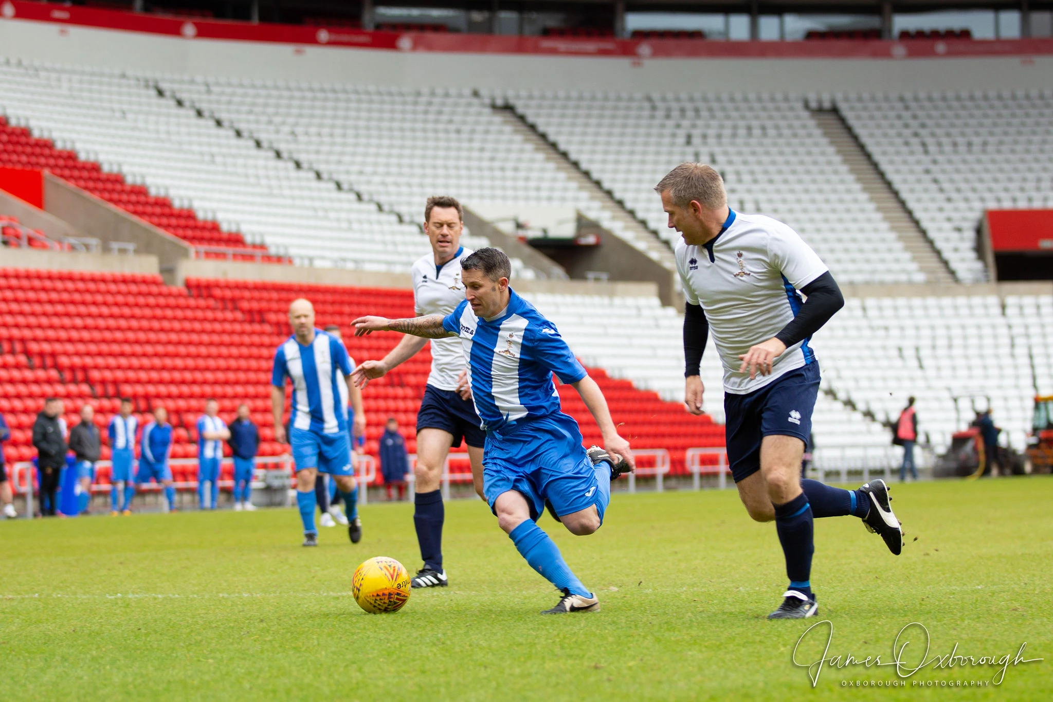 Forfusion CTO Ian Musgrave (r) challenges at the Veterans in Crisis (VICS) charity football game at the Stadium of Light