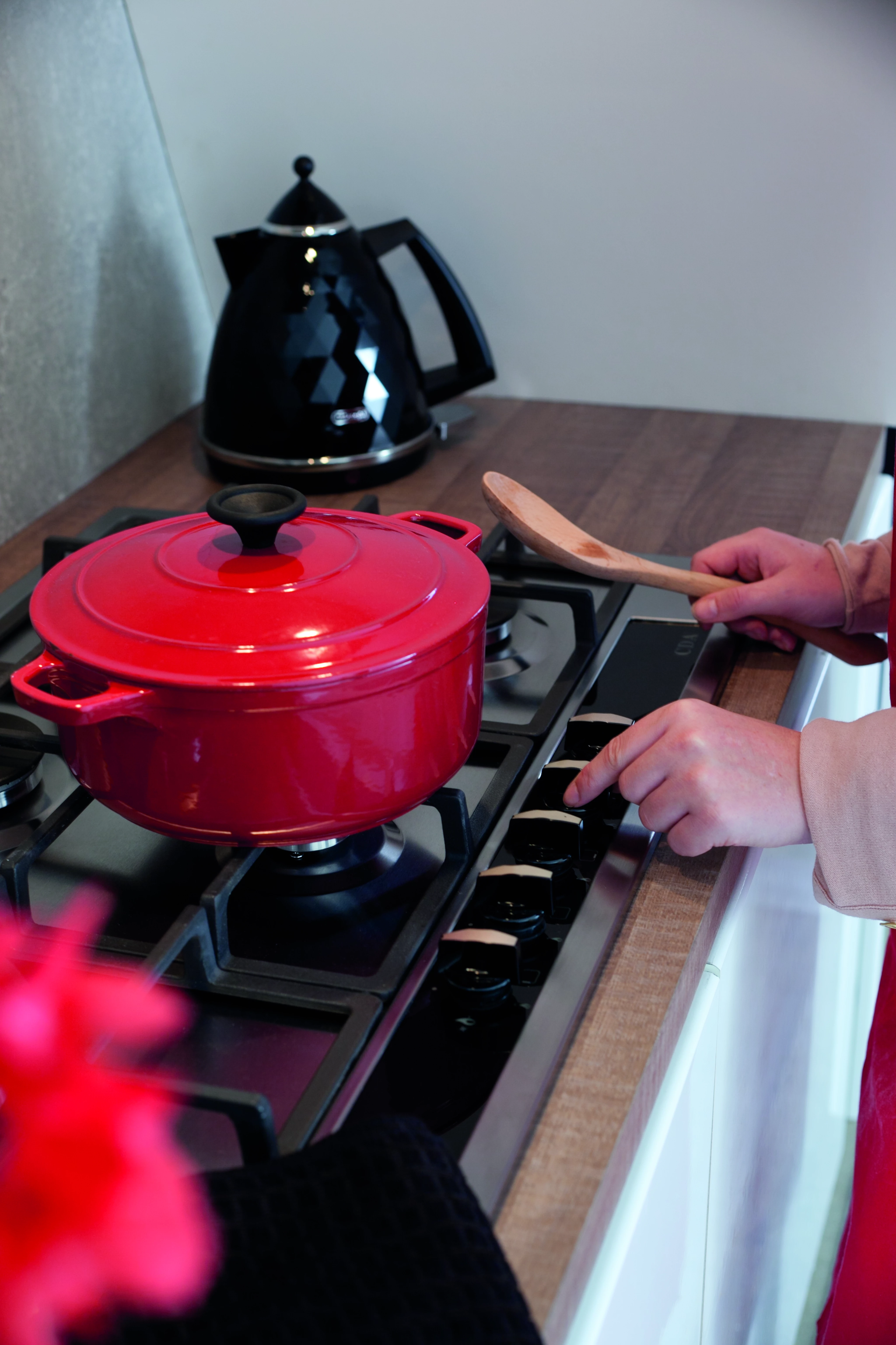 Red pan cooking on gas hob