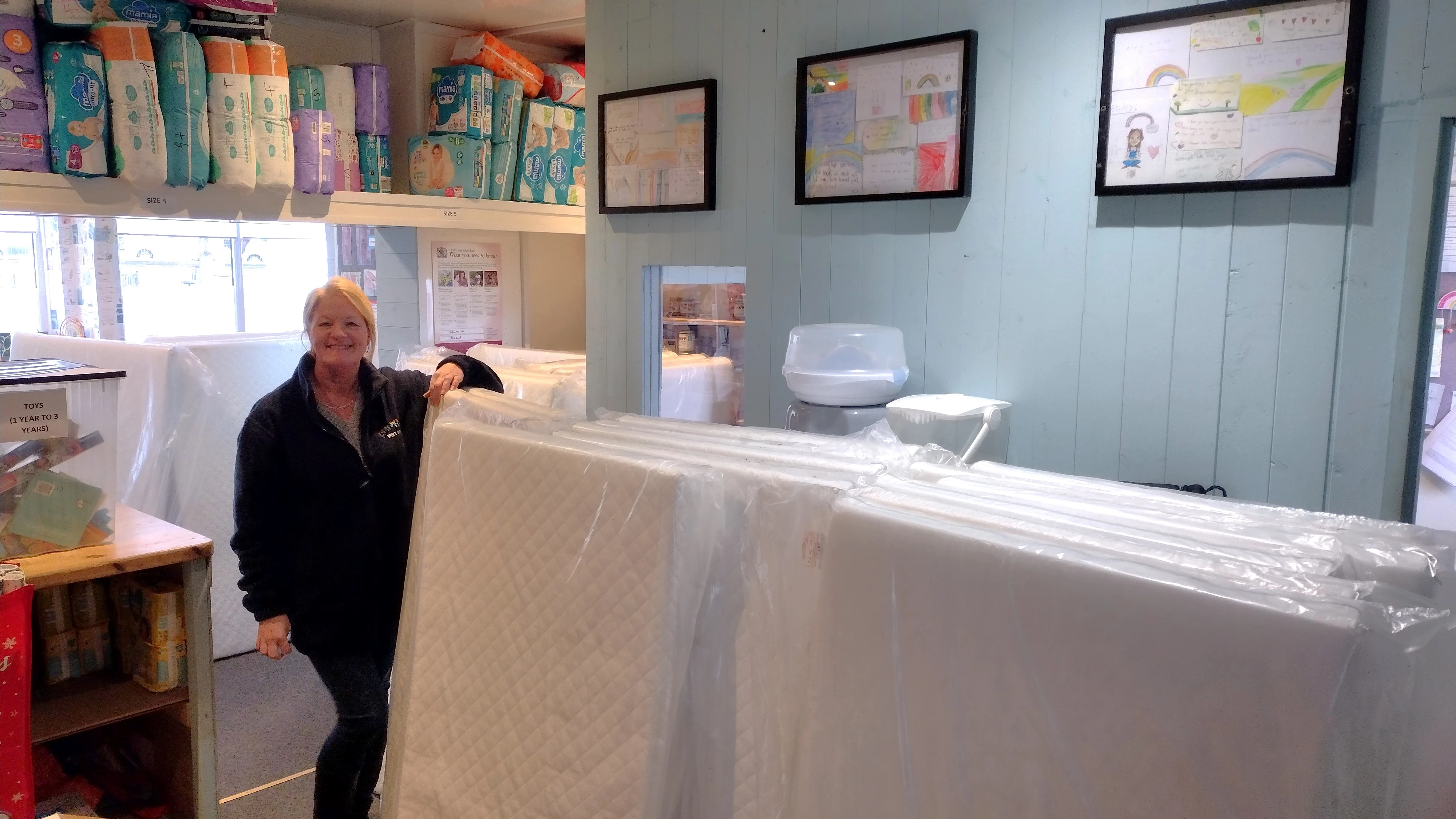 Sam Cottam, Rainbow Baby Bank Manager, with the cot mattress donations