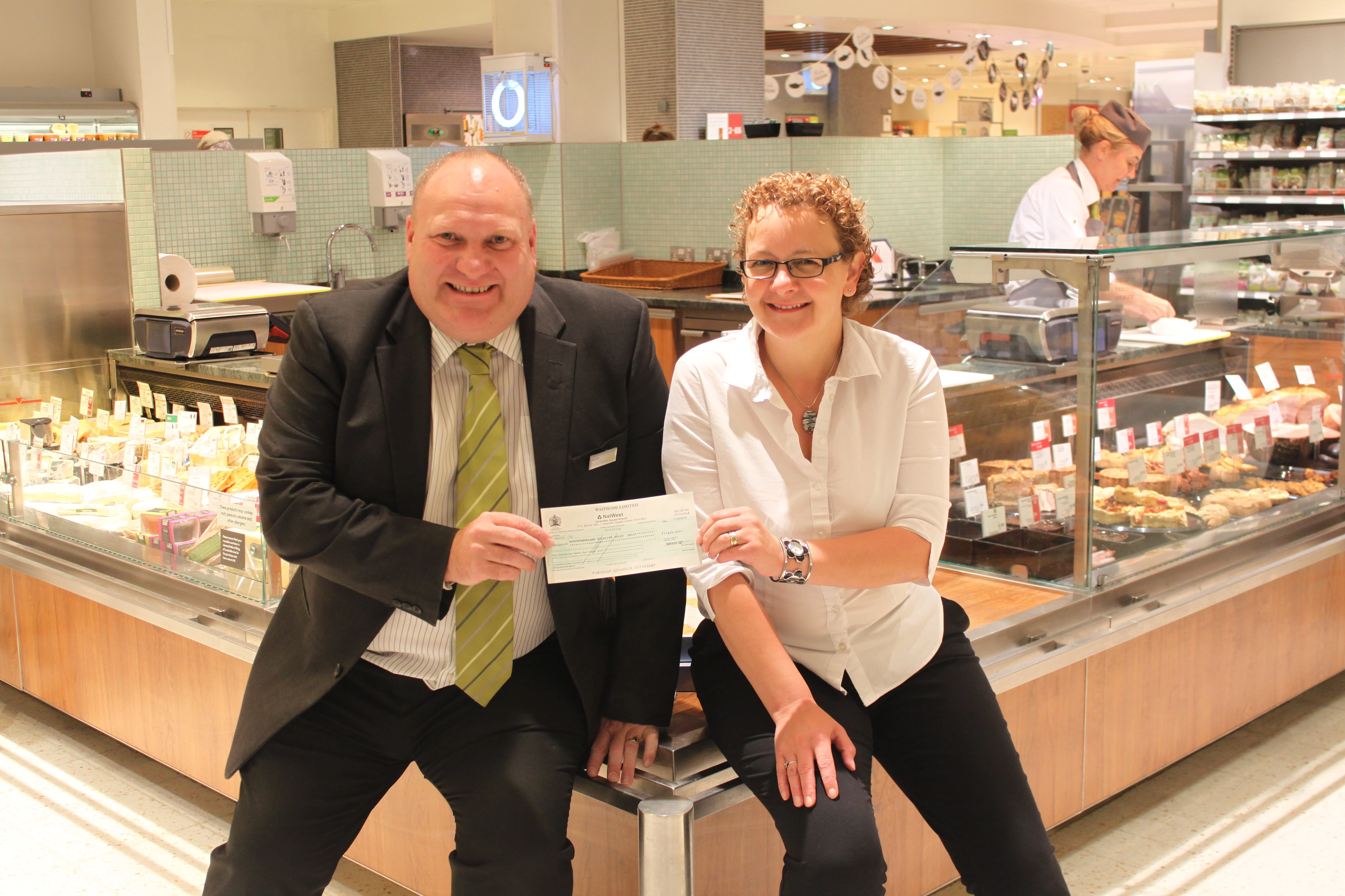 Alan Bunn, Waitrose Team Manager hands over a cheque to Helen Twelves, Northumberland Wildlife Trust Head of Business Management