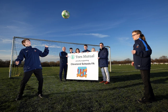 Owen Burns and Maddie Myers play head tennis watched by Cleveland Schools FA secretary Simon Carey, CSFA players Tom Lane, Ruby Wanless, Lewis Sadler, Estelle Clark and Tees Mutual chairman Mark Brooks