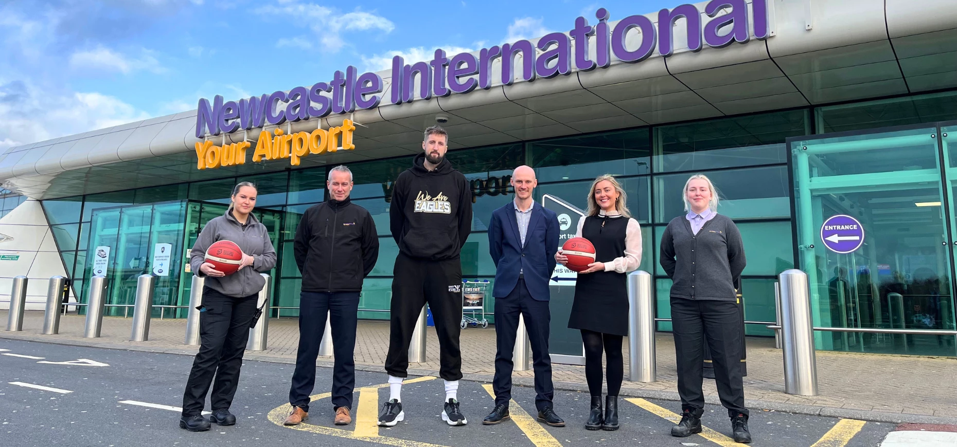 Eagles player Will Neighbour (centre) with Newcastle International Airport staff members Emily, Dave, Adam, Wallis and Megan.