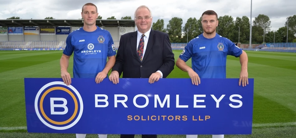 Mark Hirst of Bromleys Solicitors (centre) with Curzon Ashton players Jonathan Hunt (left) and Joe Guest