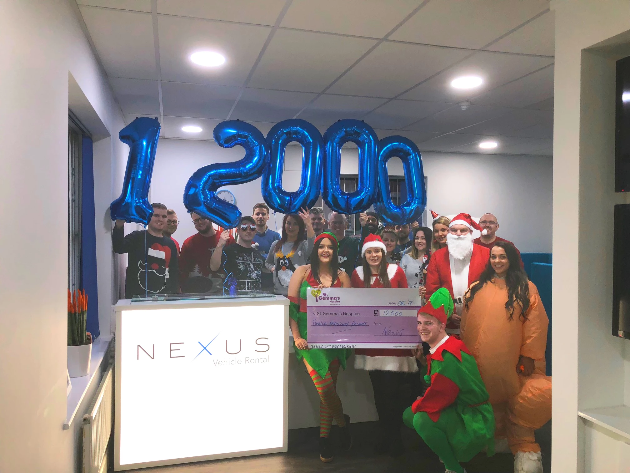 Nexus employees celebrating raising £12,000 for St Gemma's Hospice