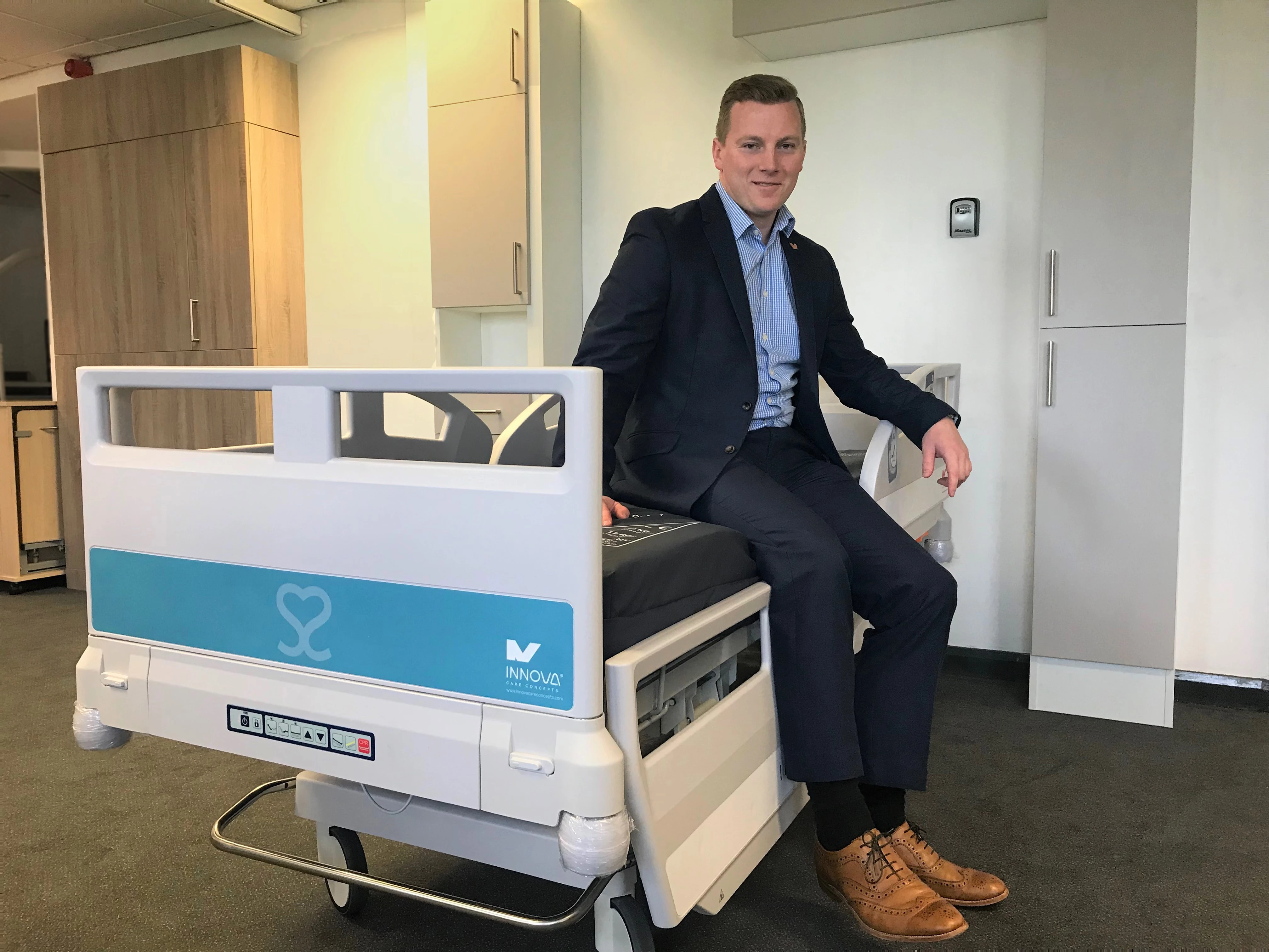 Innova Sales Director Joe Hulbert sat on an Interlude Newcare V2 bed