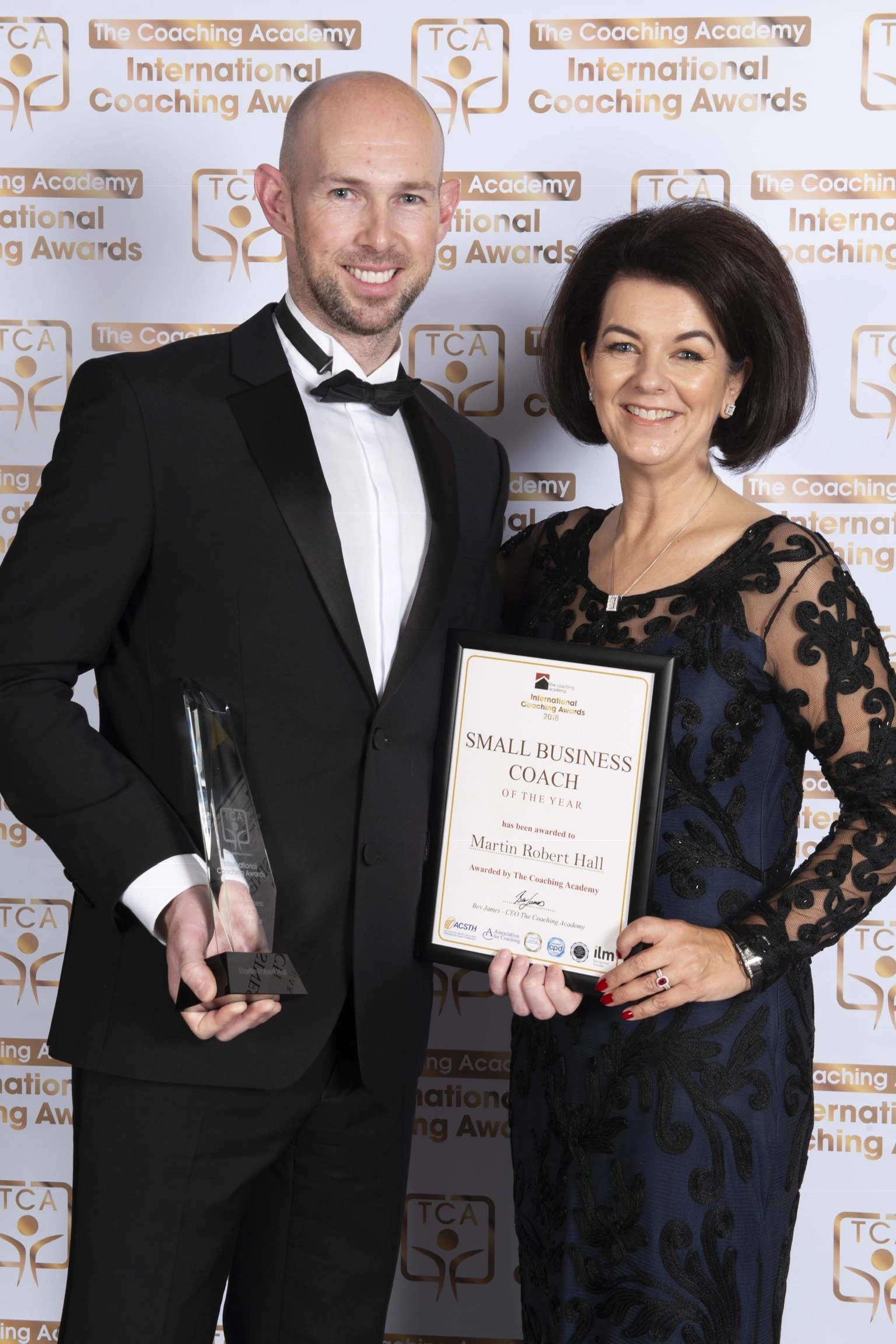 Martin picking up his award from Bev James, CEO of the Coaching Academy.