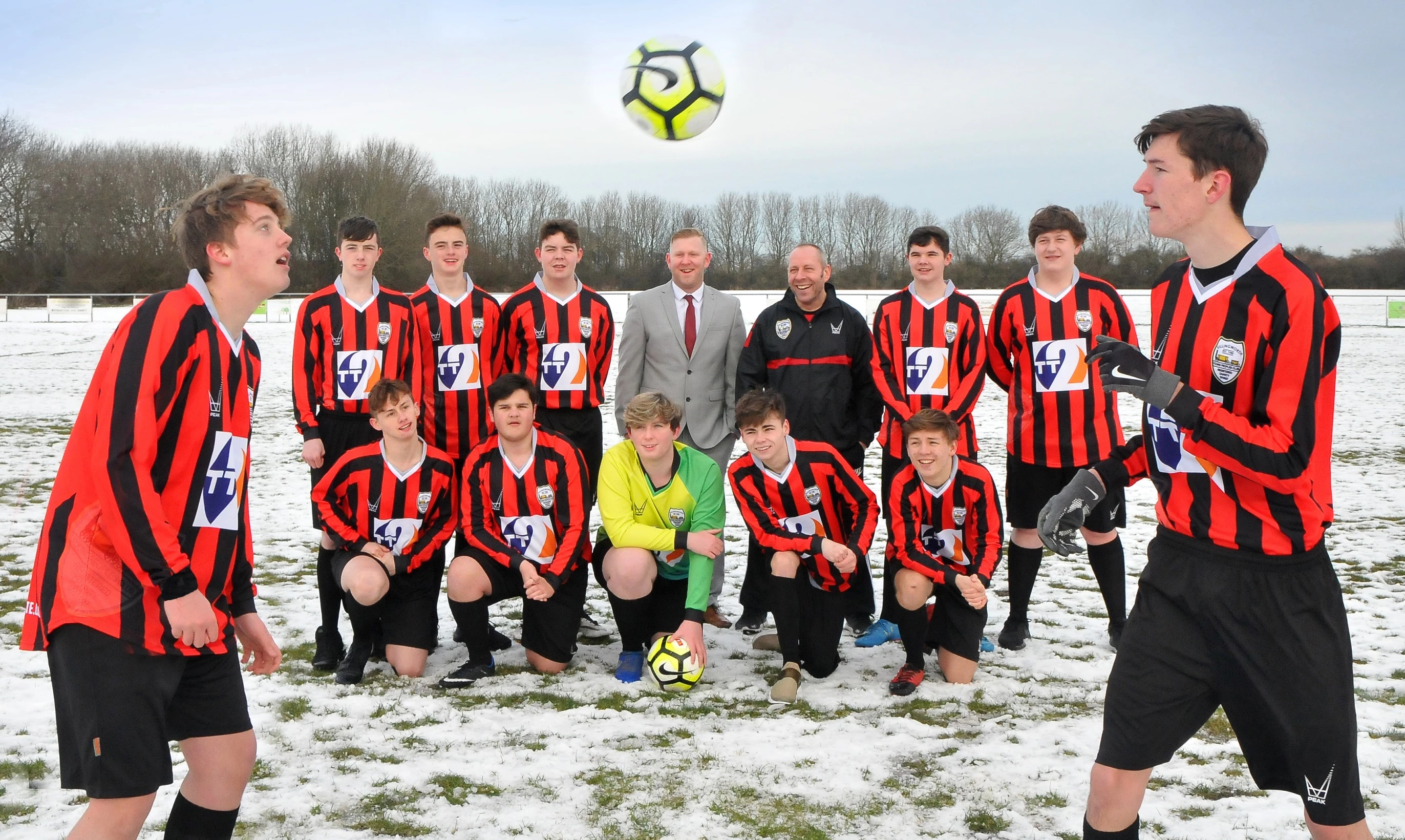 Team captain Ethan Myers (left) and John Clyde (right) head the ball watched by the other players from KYPC, with Shaun Simmons from TT2 and Club Manager Mick Manccini