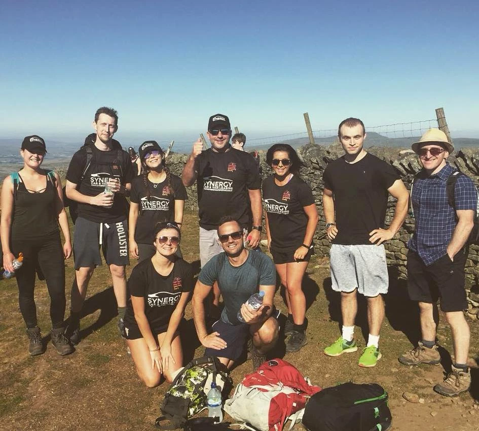 Scaling new fundraising heights: Paul Parkinson (centre, back row) with Synergy team members.  