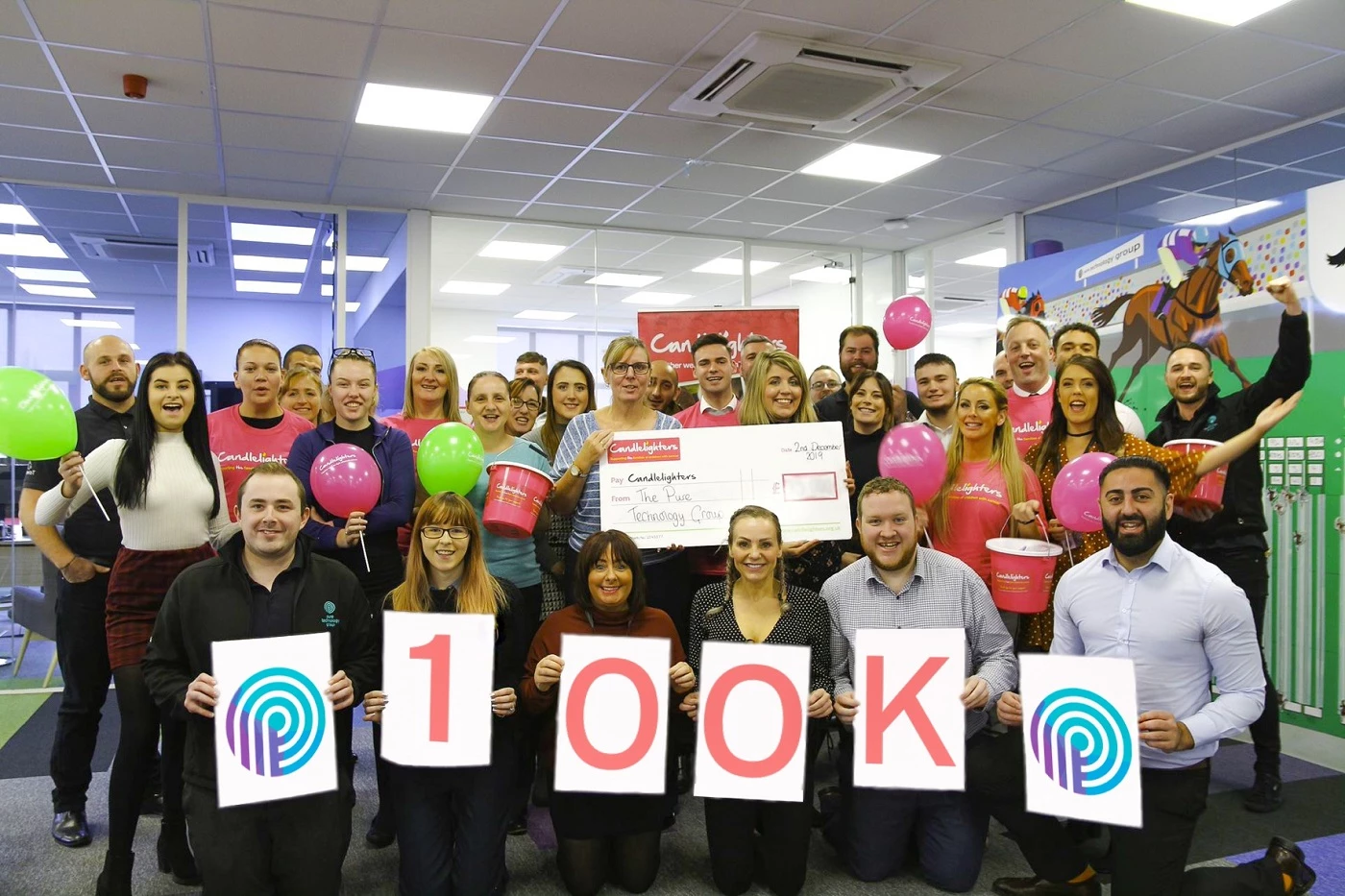 Pre-social distancing rules - the team at pure technology group, together with Amy Harrison from Candlelighters, celebrating the Summer100k initiative