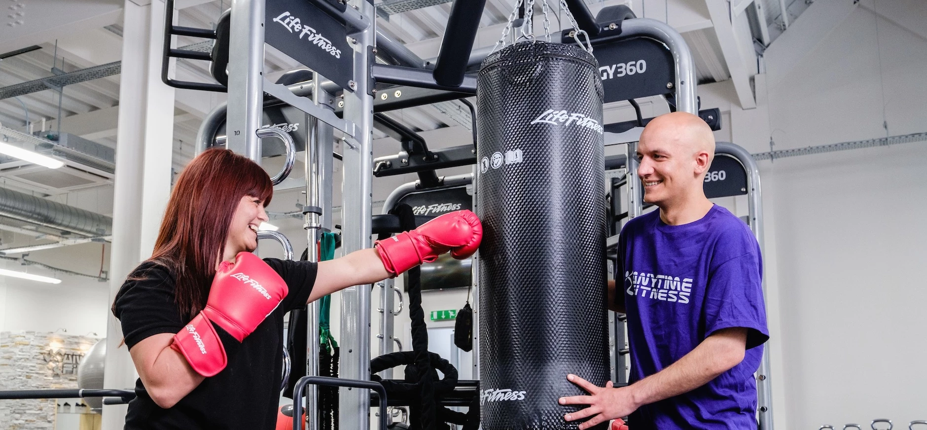 General Manager Sasha Young works out with Anytime Fitness franchise owner Neel Sodha.