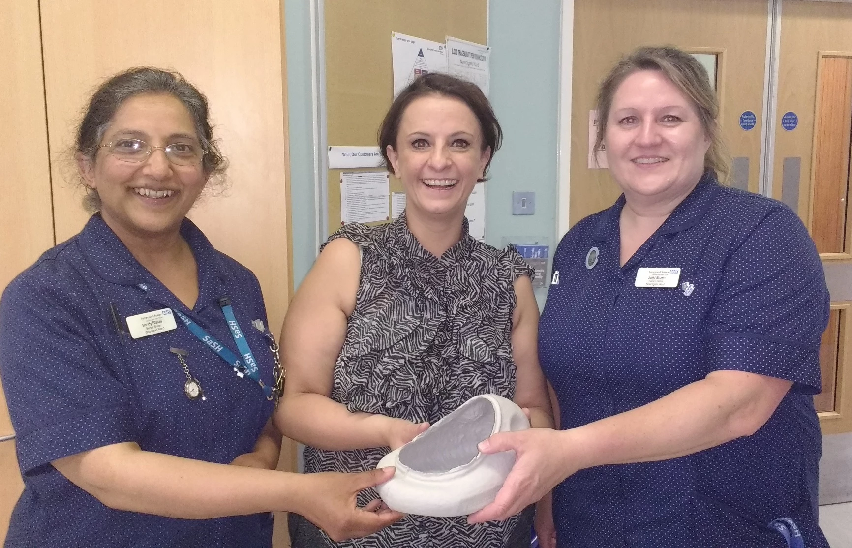 Pictured (l-r) with the VernaFem female urinal are Sandhya Blakey, Vernacare's Sophie Otenaike, and ward sister Jacqueline Brown 