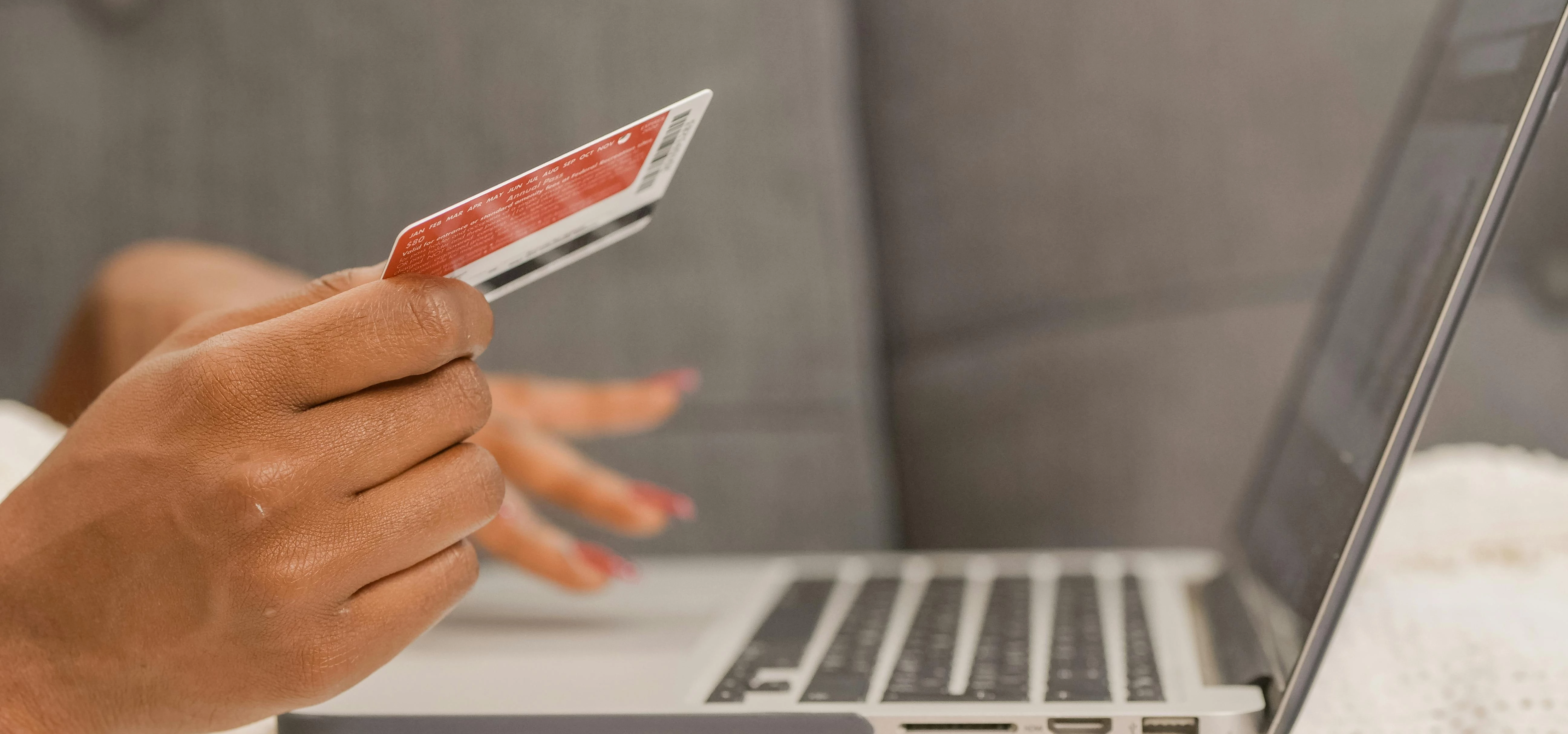 Person Holding Credit Card Doing Online Shopping