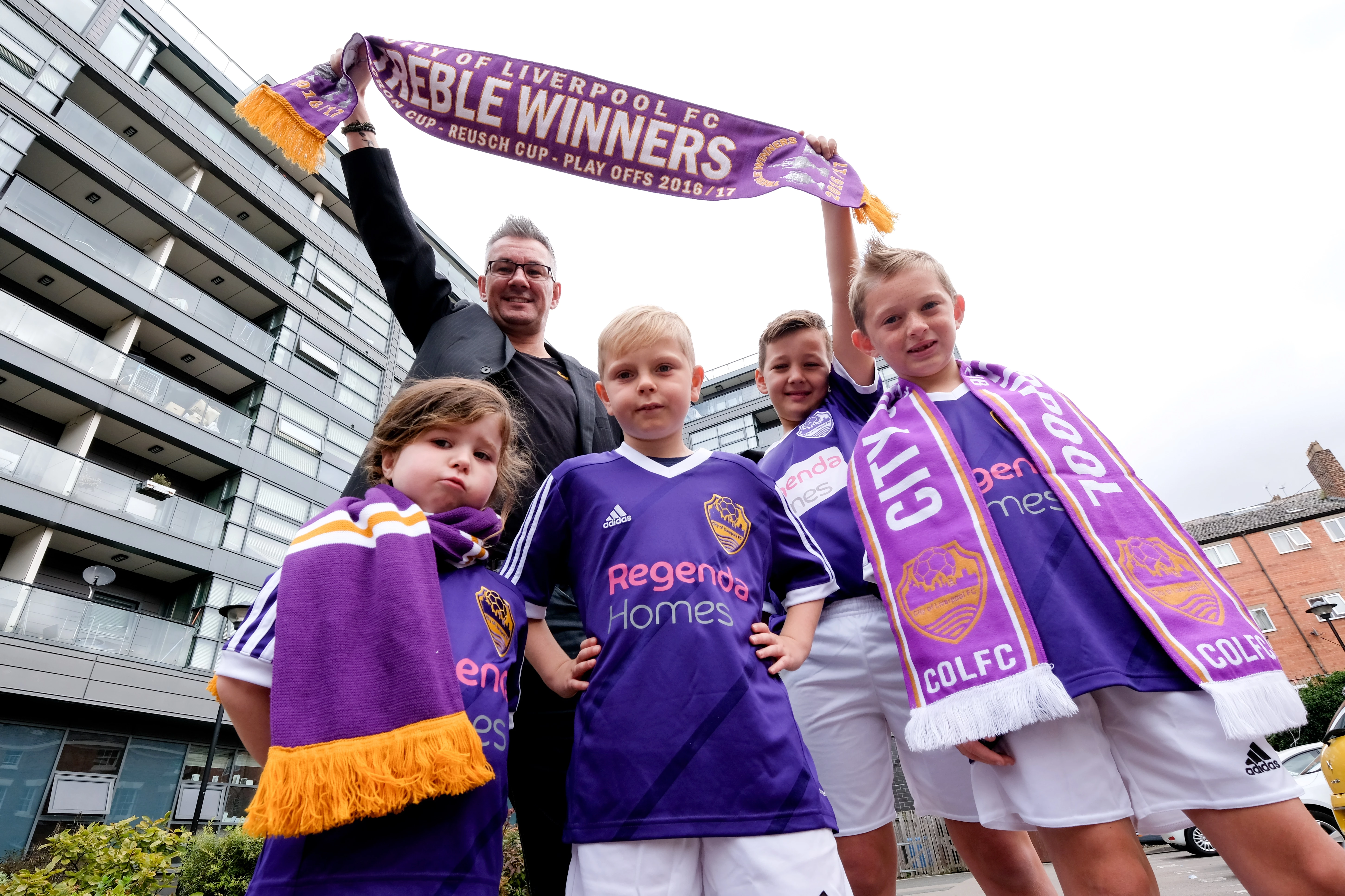 City of Liverpool FC Club Media Director, Gary Johansen, with local children outside Dukes Terrace