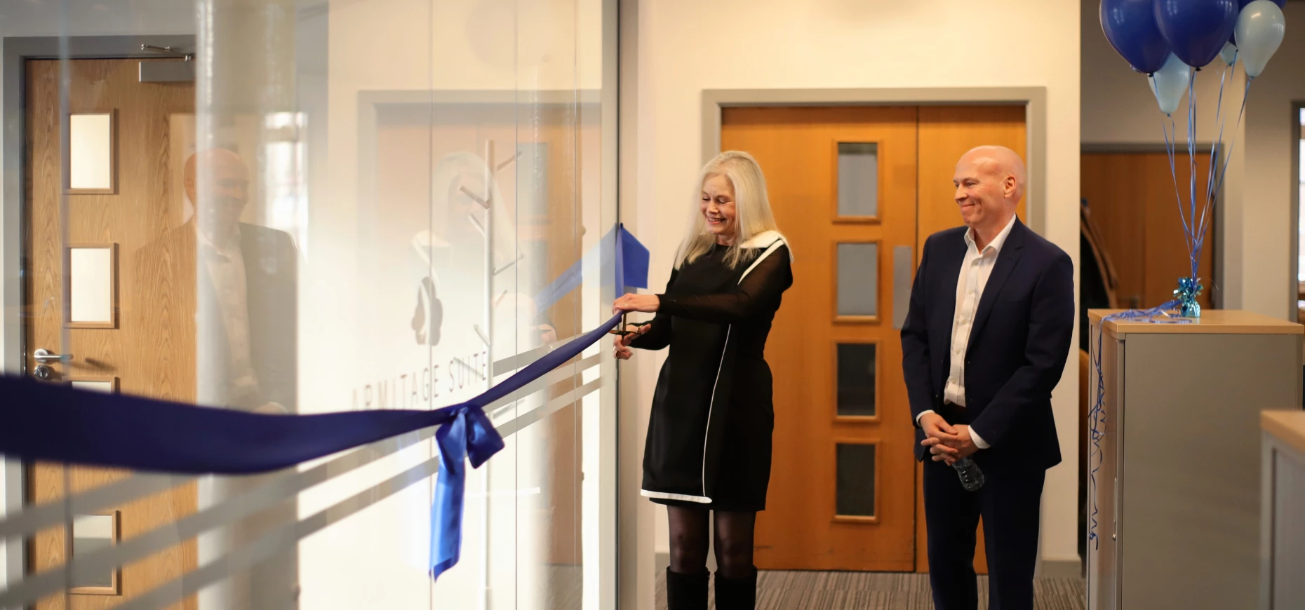 Basia Armitage cutting the ribbon  on the Armitage Suite with James Clarkson, CEO of Adventoris.