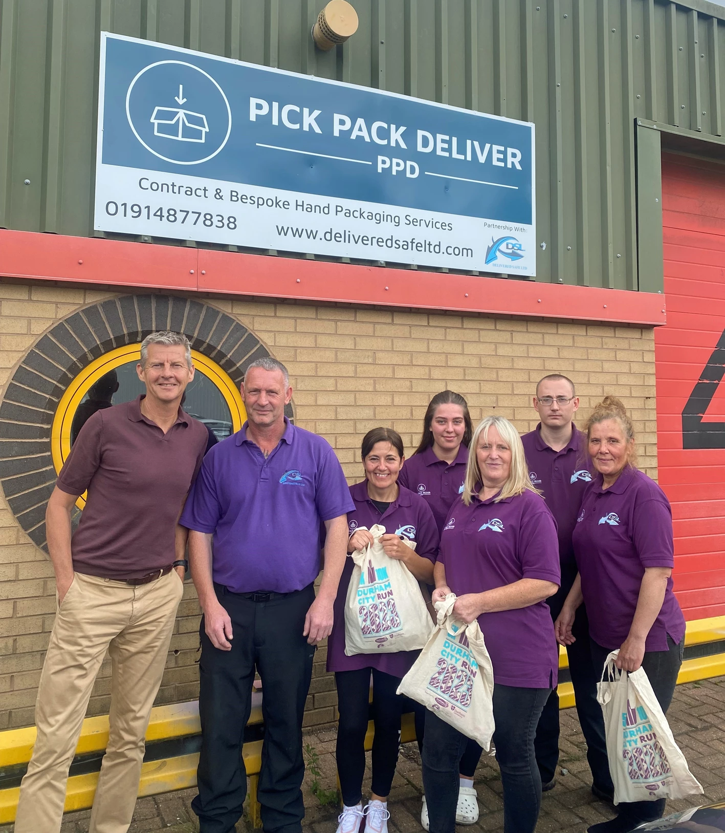 Steve Cram next to Mark Hogarth and the Pick Pack Deliver team