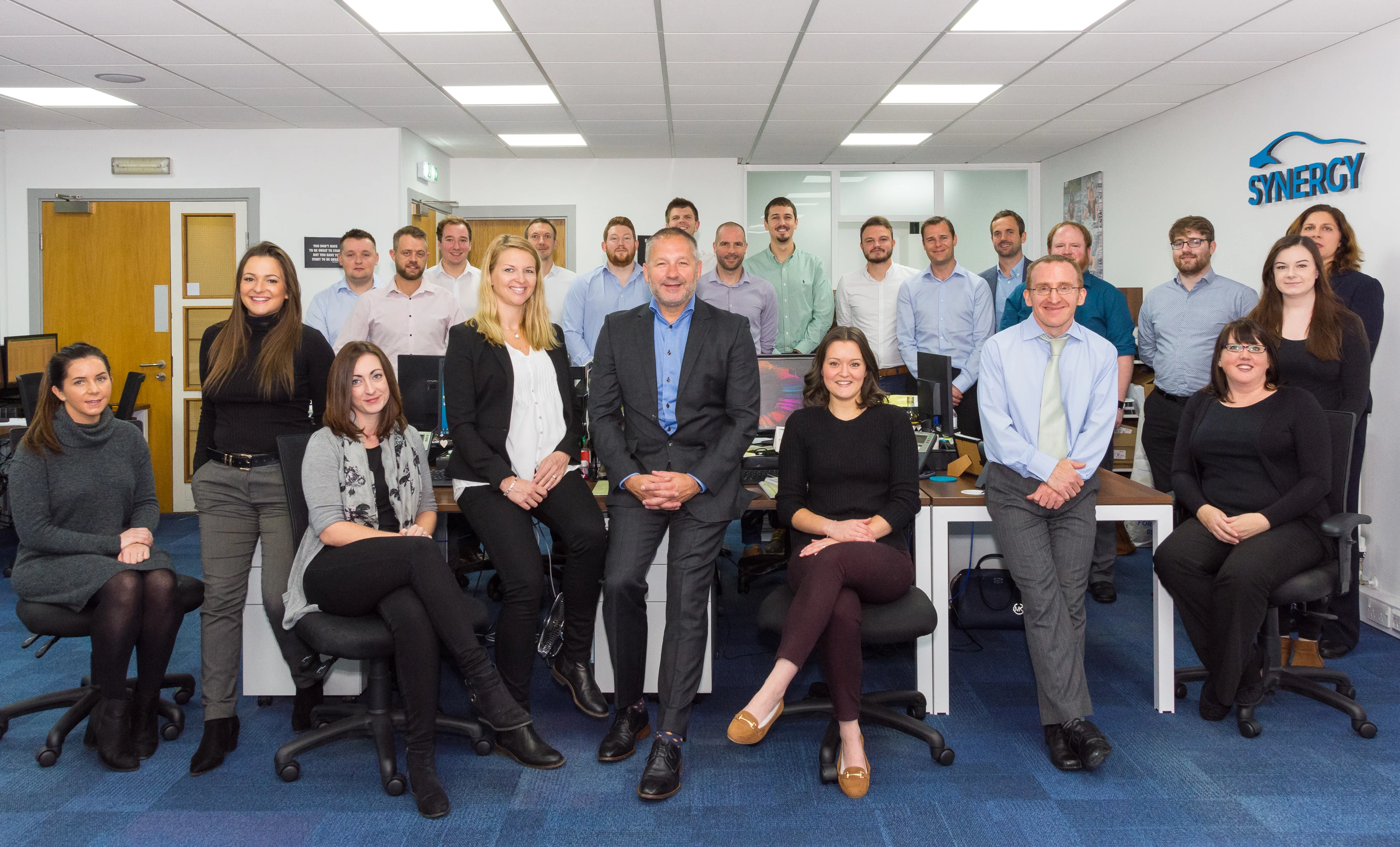 Smiles of success: Synergy Automotive MD, Paul Parkinson and team members.  