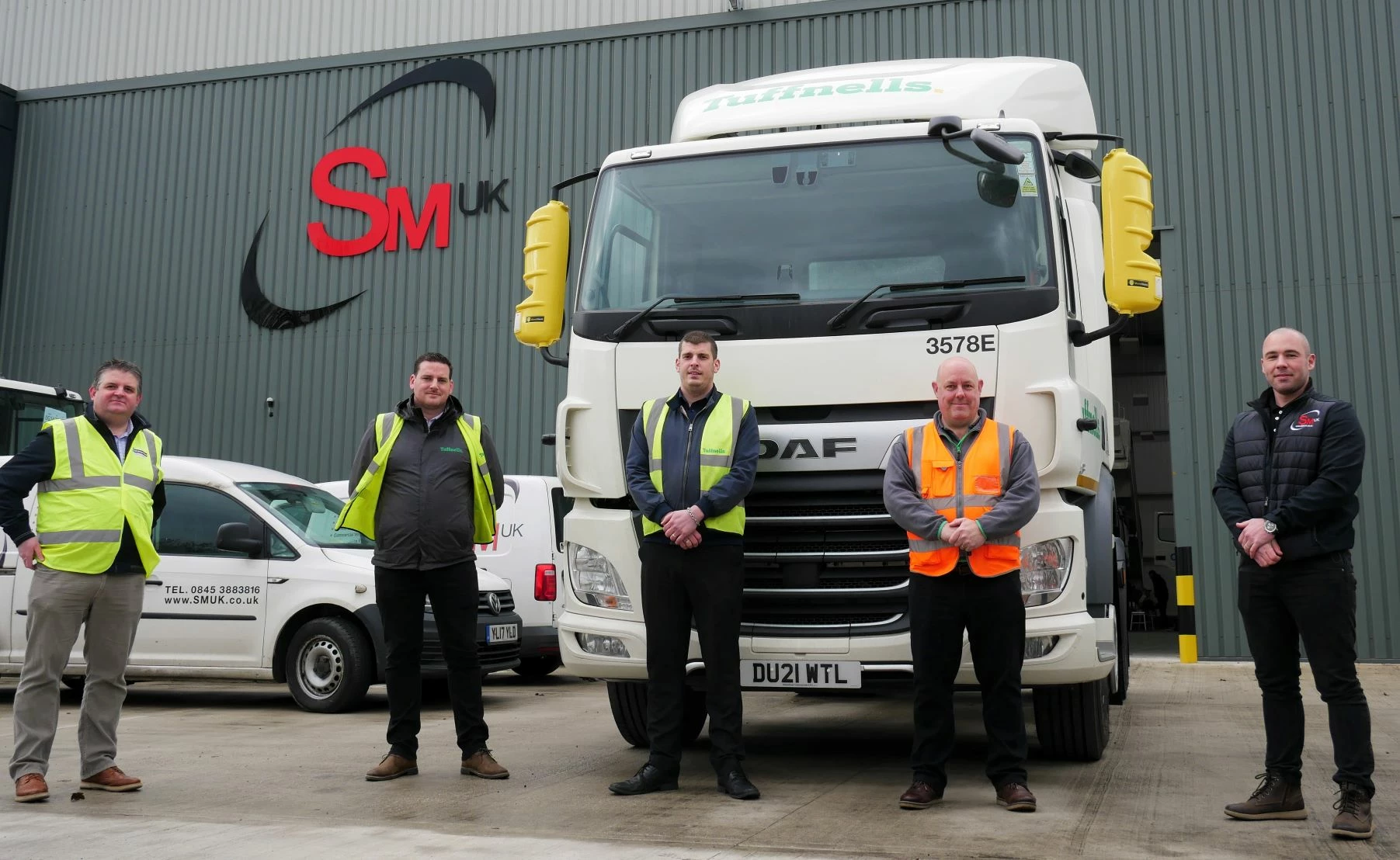 SM UK and Tuffnells staff with vehicle equipped with new safety system