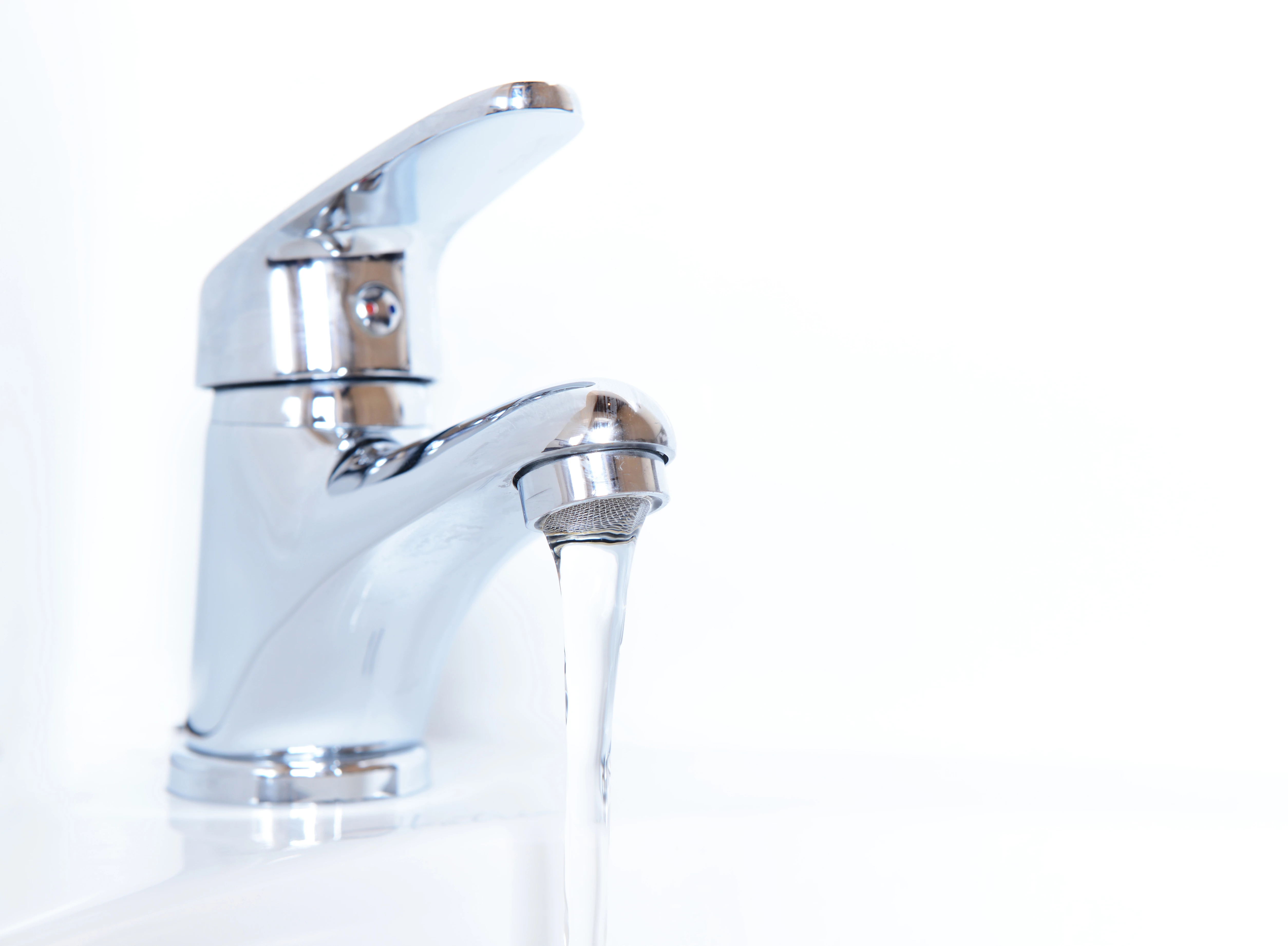 Close-up of human hands being washed under faucet in bathroom, isolated on white