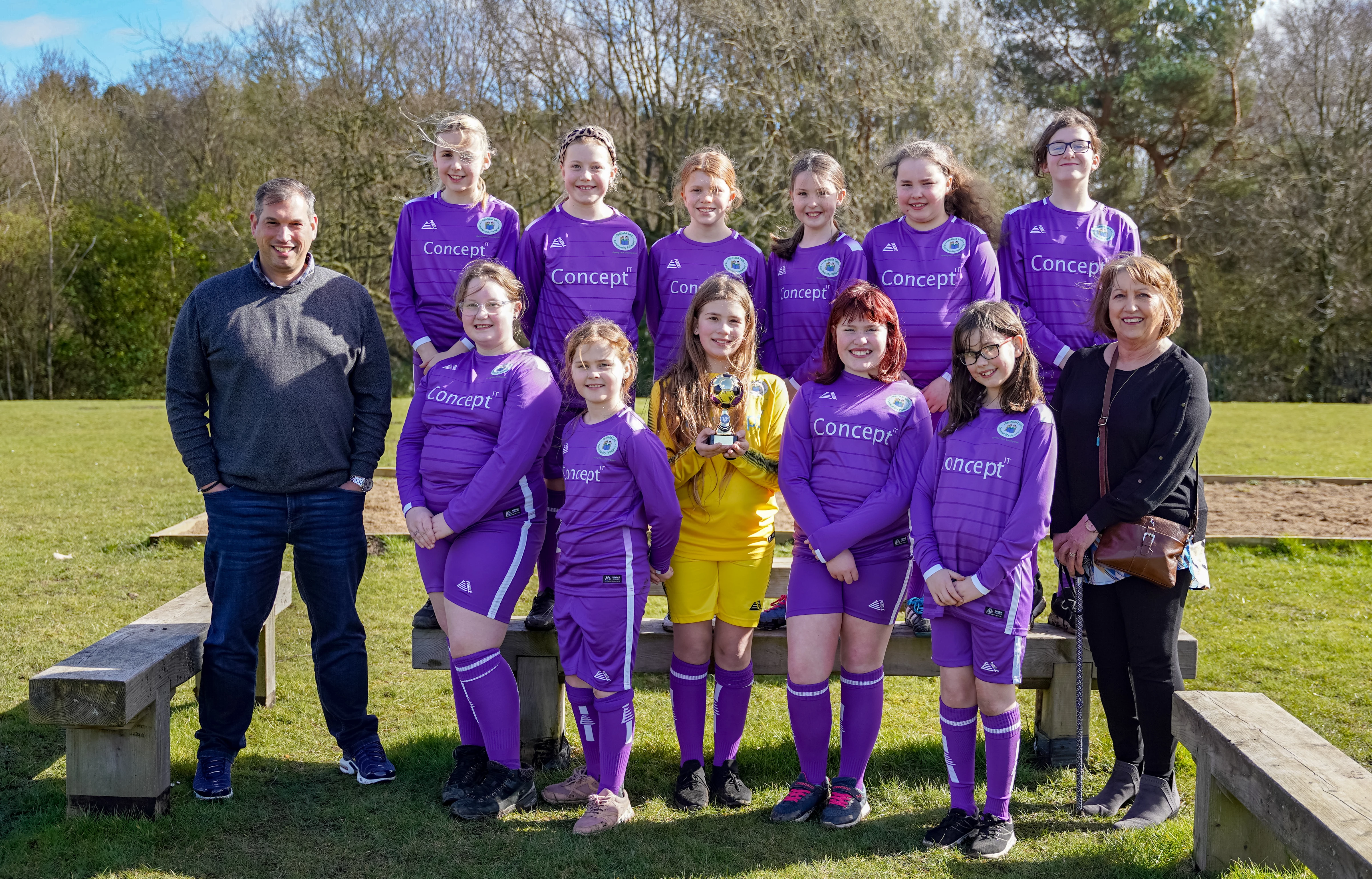 Concept IT managing director Kevin Embleton (left) joined by the Tanfield girls football team and Catherine Embleton (right)