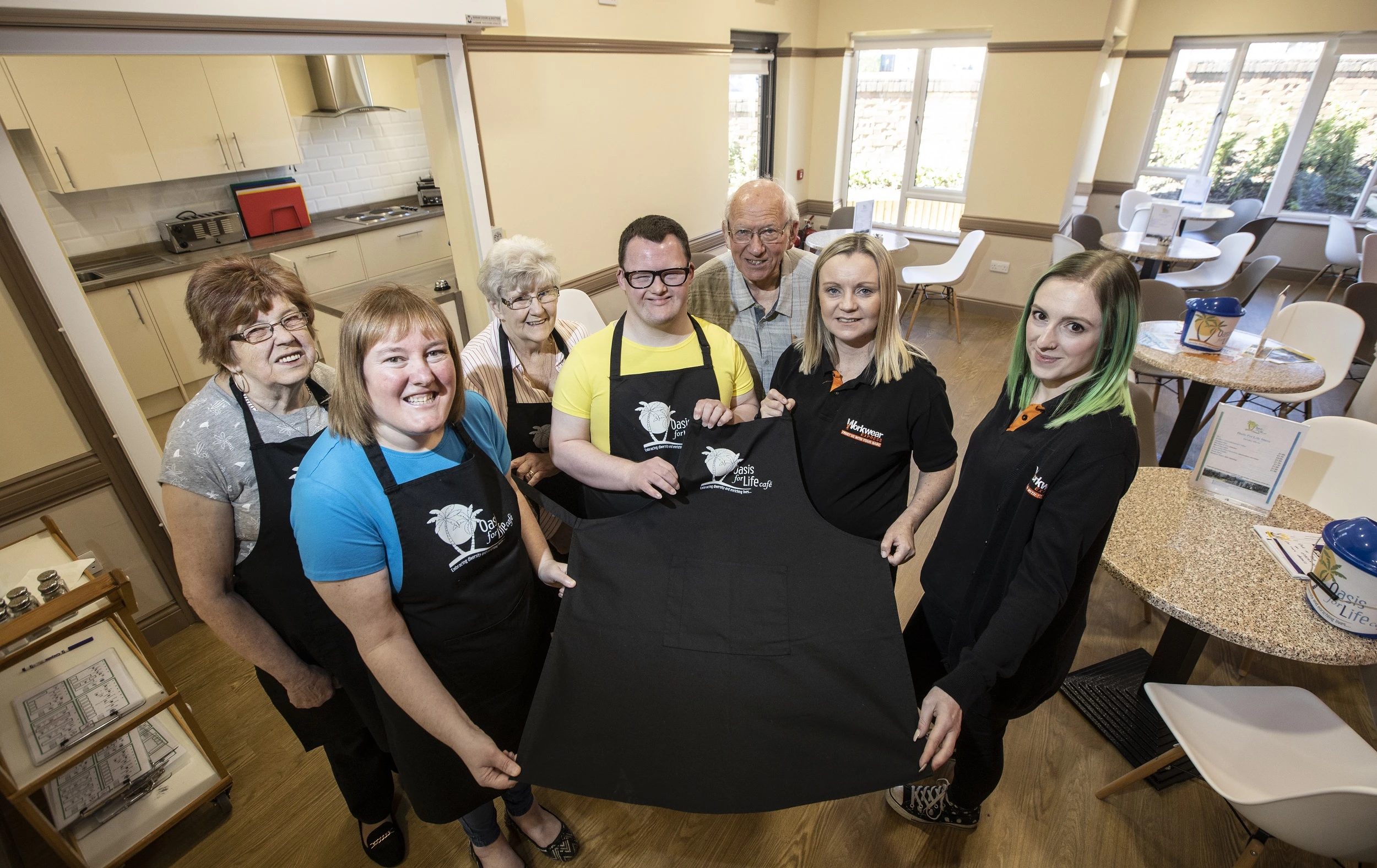 (Left to right) Margaret Thompson, Vicky Penaluna, Sylvia Lewins, Matthew Cooke and Richard Lewins from Oasis for Life Café with Joanne Hughes and Heather Podmore from Workwear Express.