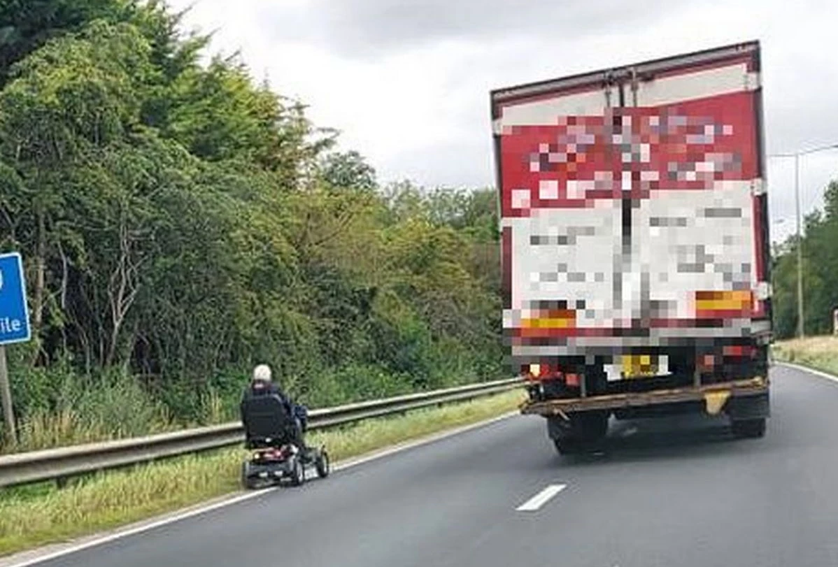 Mobility Scooter Next to Busy Road