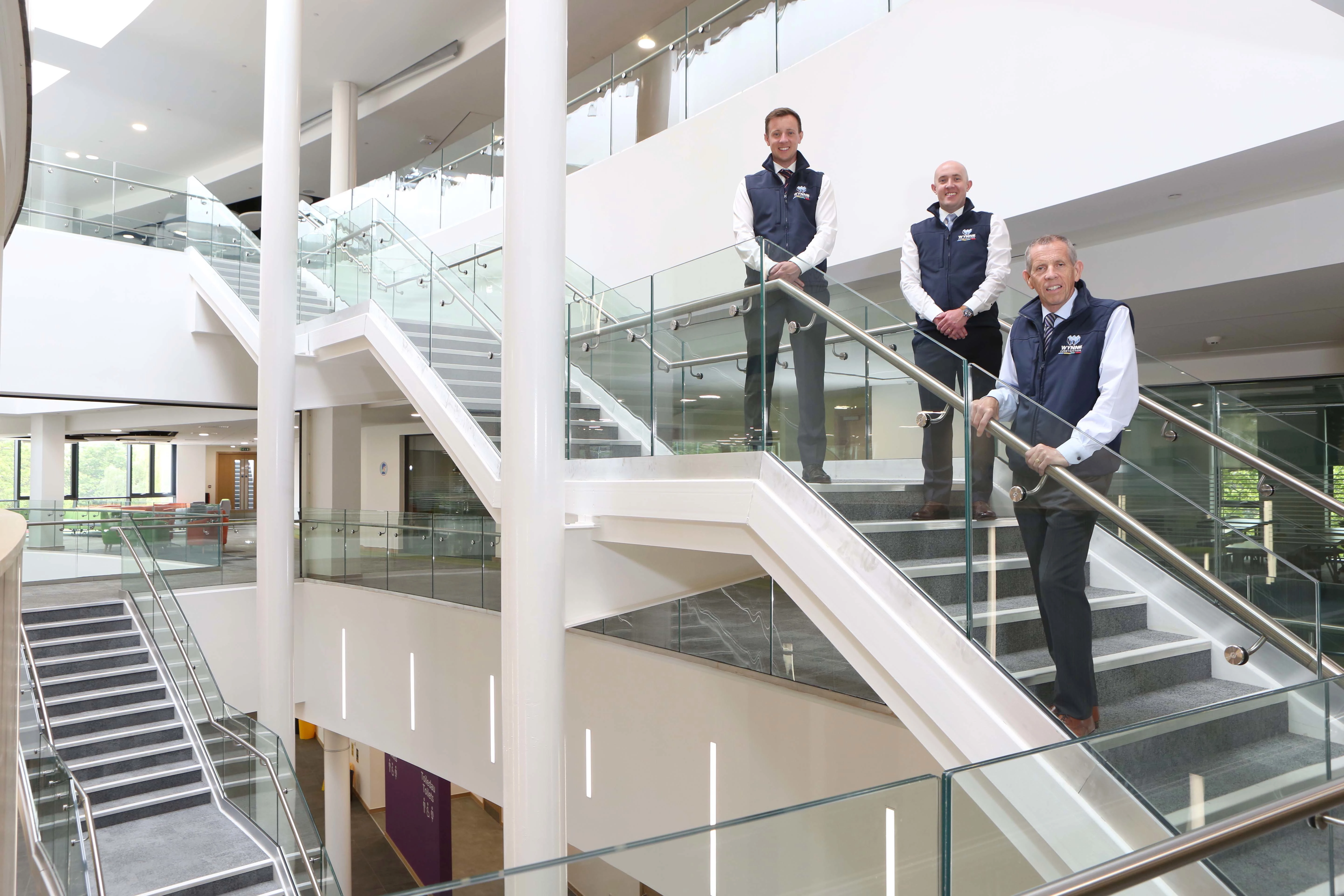 L-R: Construction Manager Richard Wynne, Quantity Surveyor David Wynne and Managing Director Chris Wynne of Wynne Construction survey the work done by the company at the Coleg Cambria Yale site.