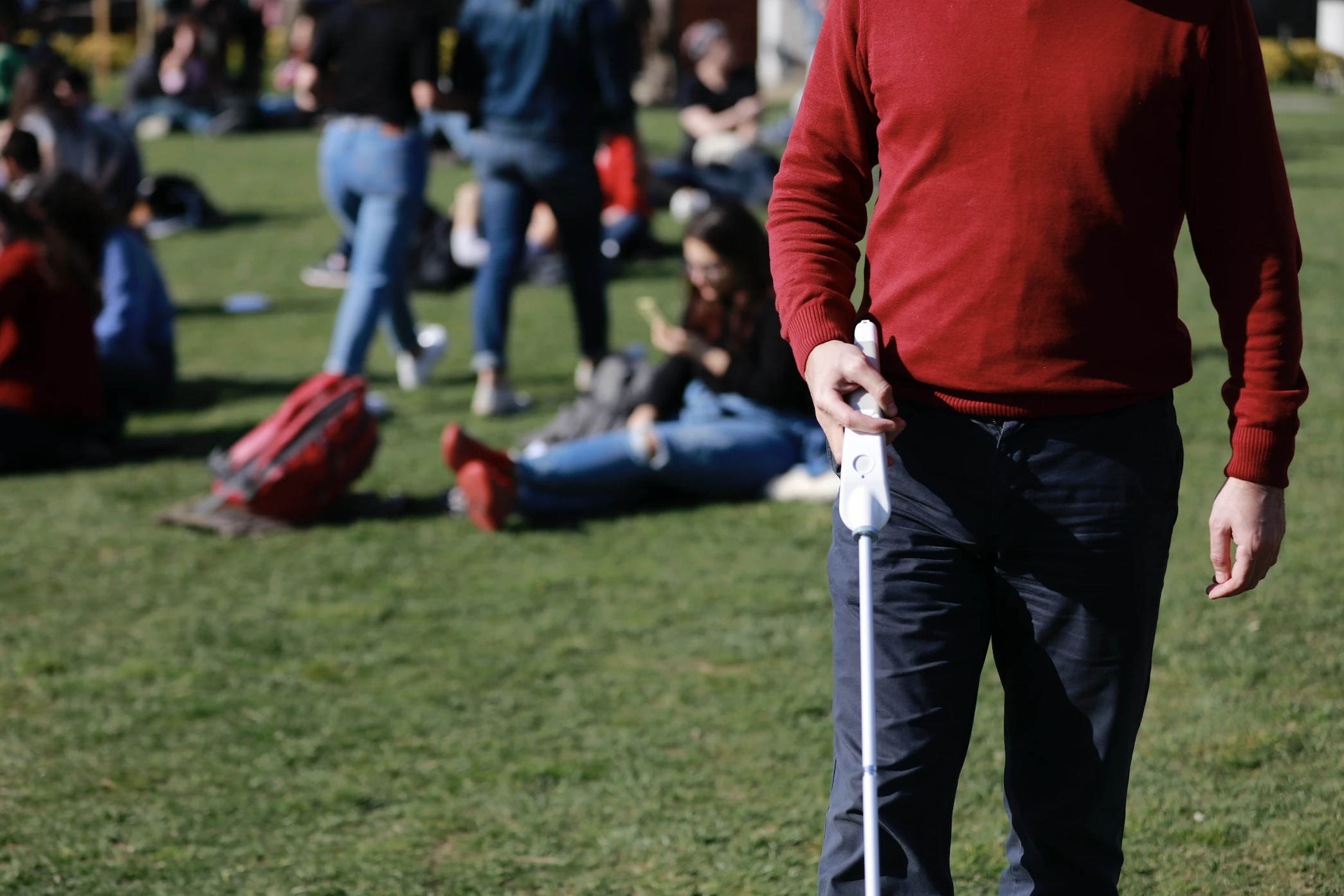 Visually impaired man walking in park with We Walk cane 