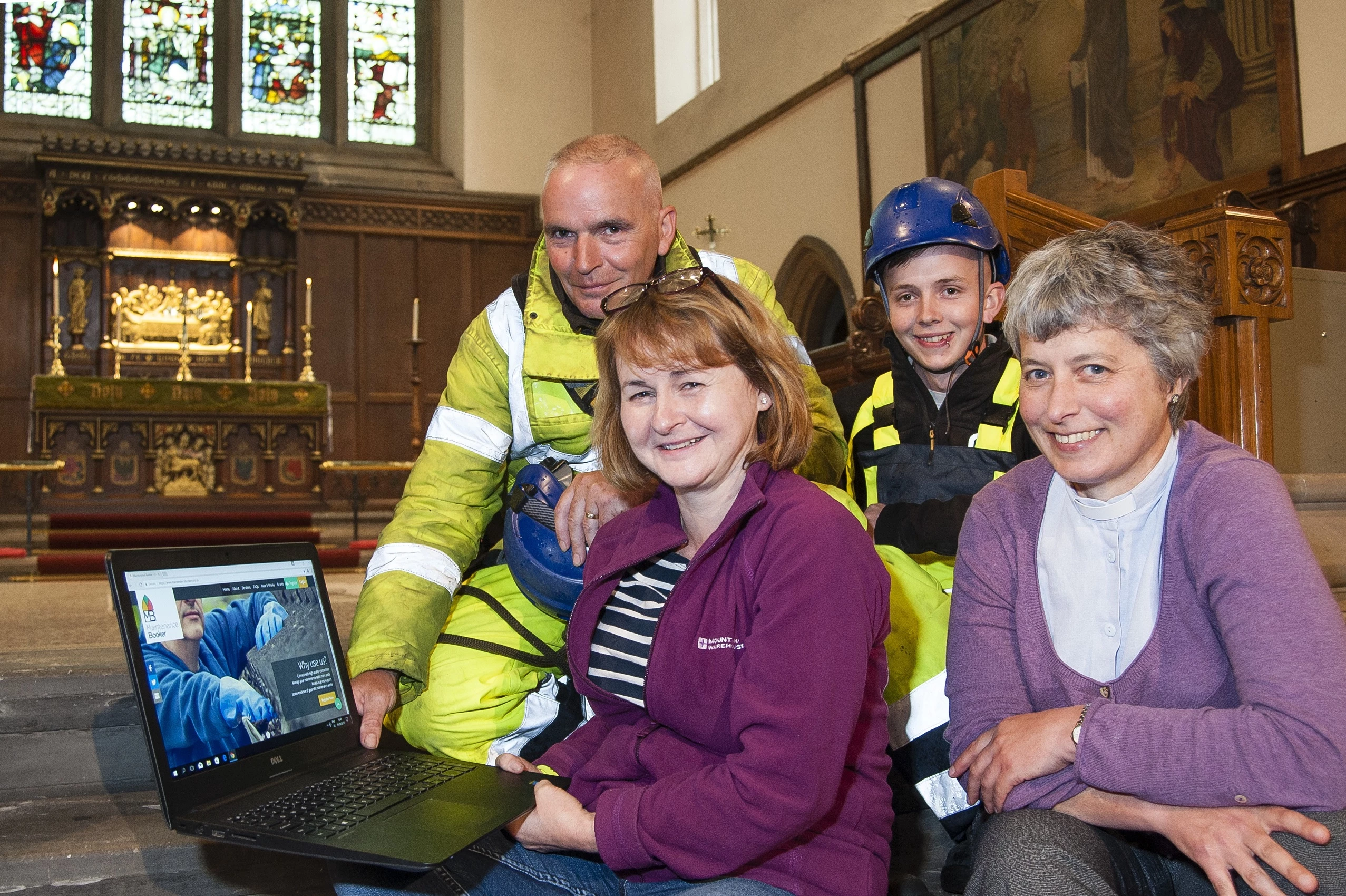 Priest in charge of St Augustine's Claire Dawson (right) and Janet Edmund with Stone Technical Services’ steeplejack and general foreman, Paul Tinkler (left), and rope access technician, Liam Baird, at the launch of the MaintenanceBooker website at St Aug