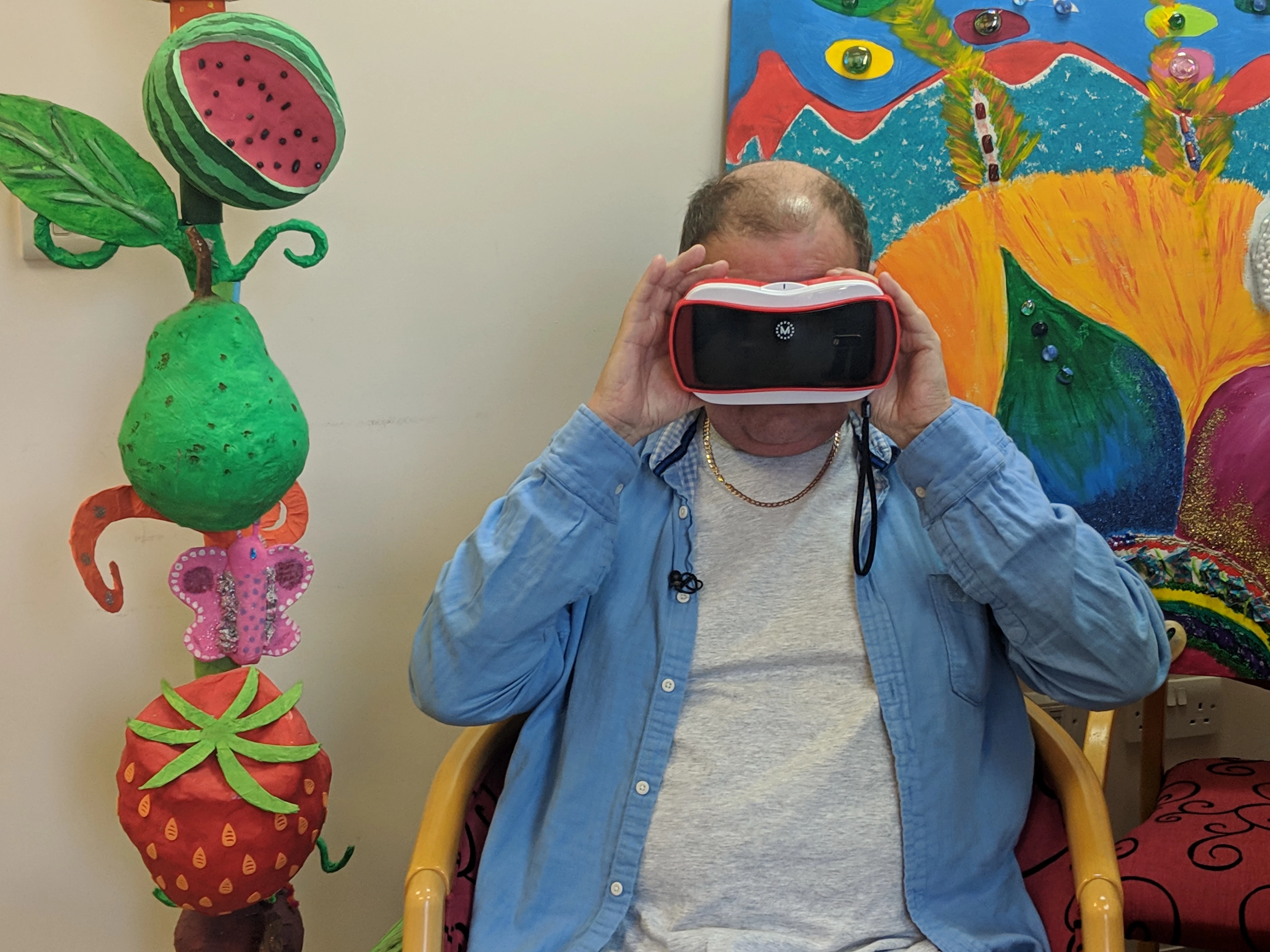 East Lancashire Hospice patient John Taylor trying the VR headset