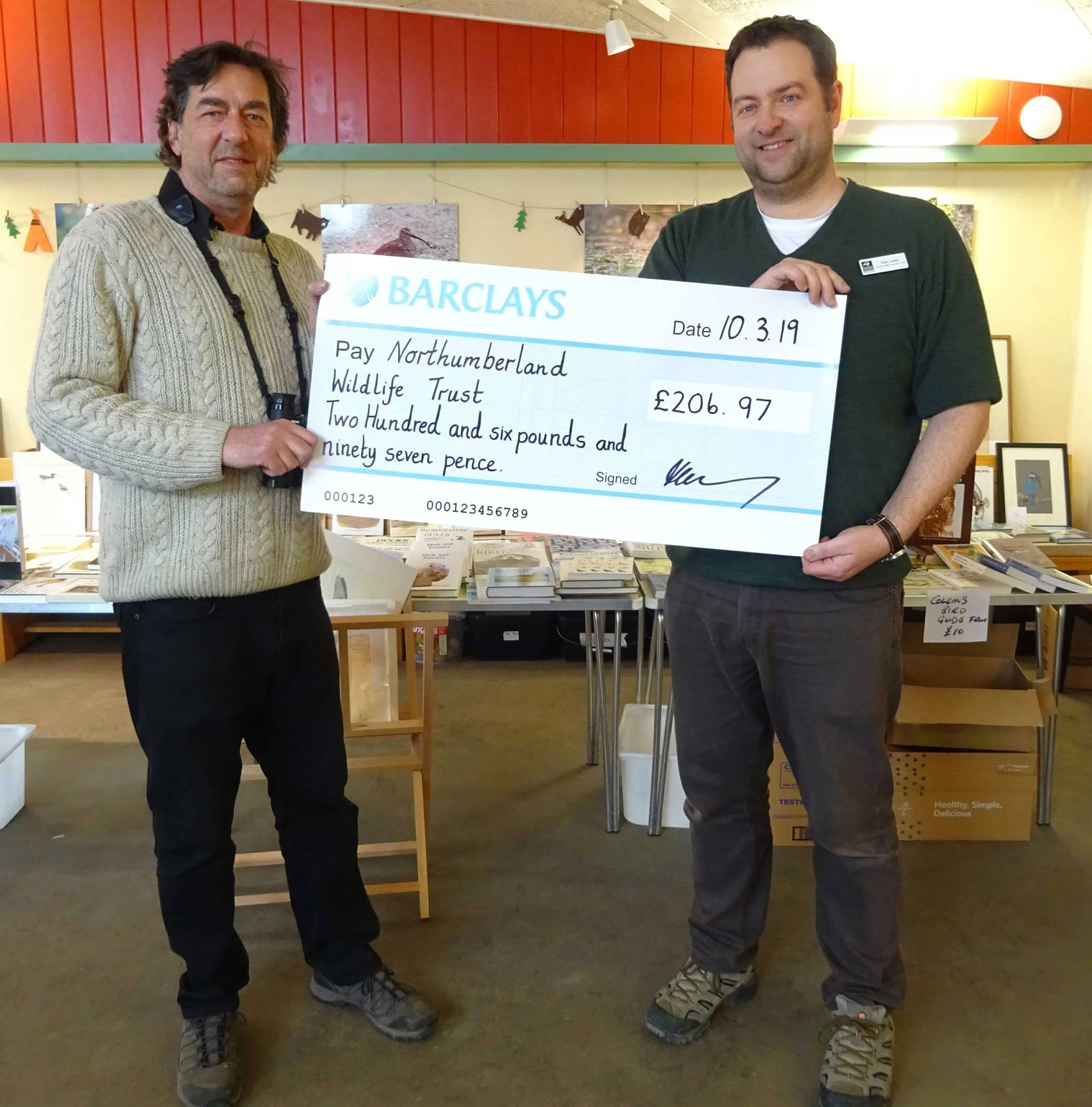 Mike Fielding (left) birdersmarket.com presenting the donation to Alex Lister (right)