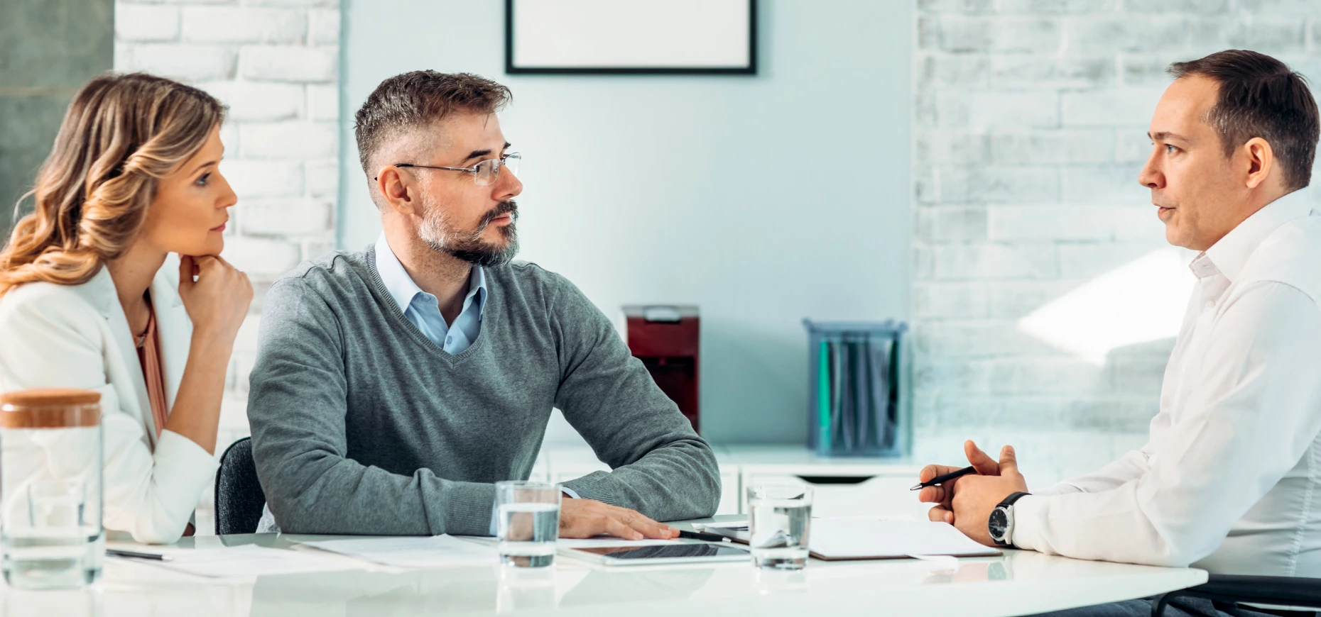 A couple sitting down for a conversation with a financial advisor.