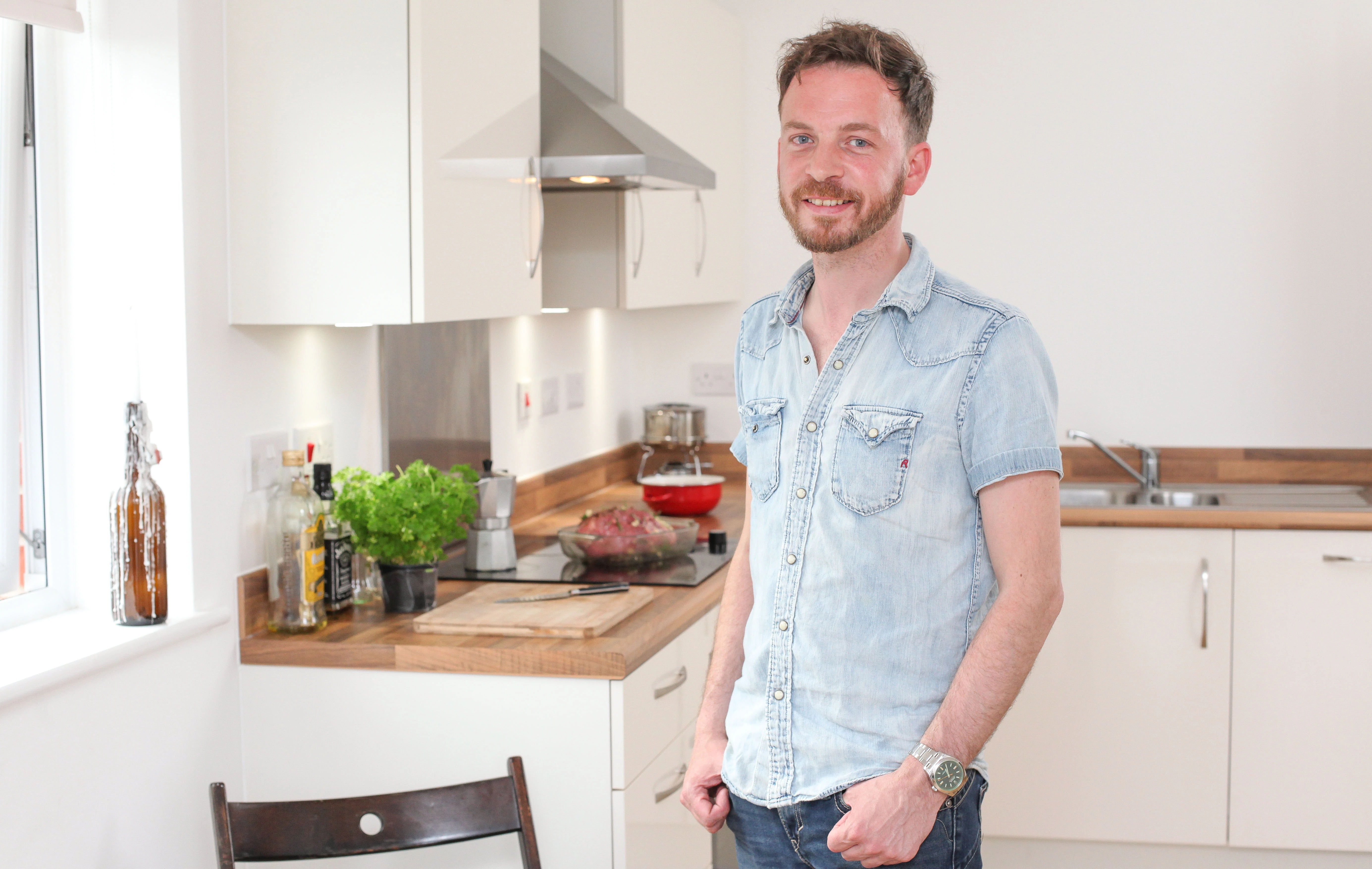 John Pyle, SDL Group's 1000th tenant, inside his rented apartment.