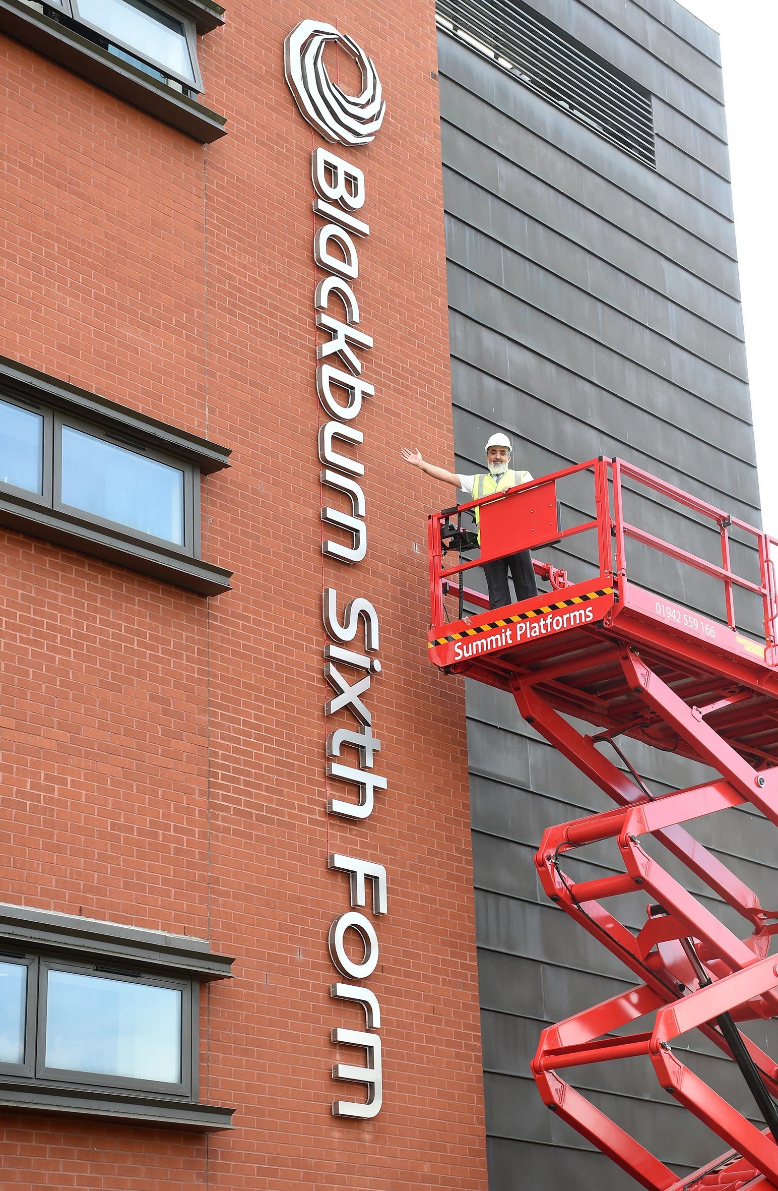 Fazal Dad, Principal, with the new Blackburn Sixth Form signage