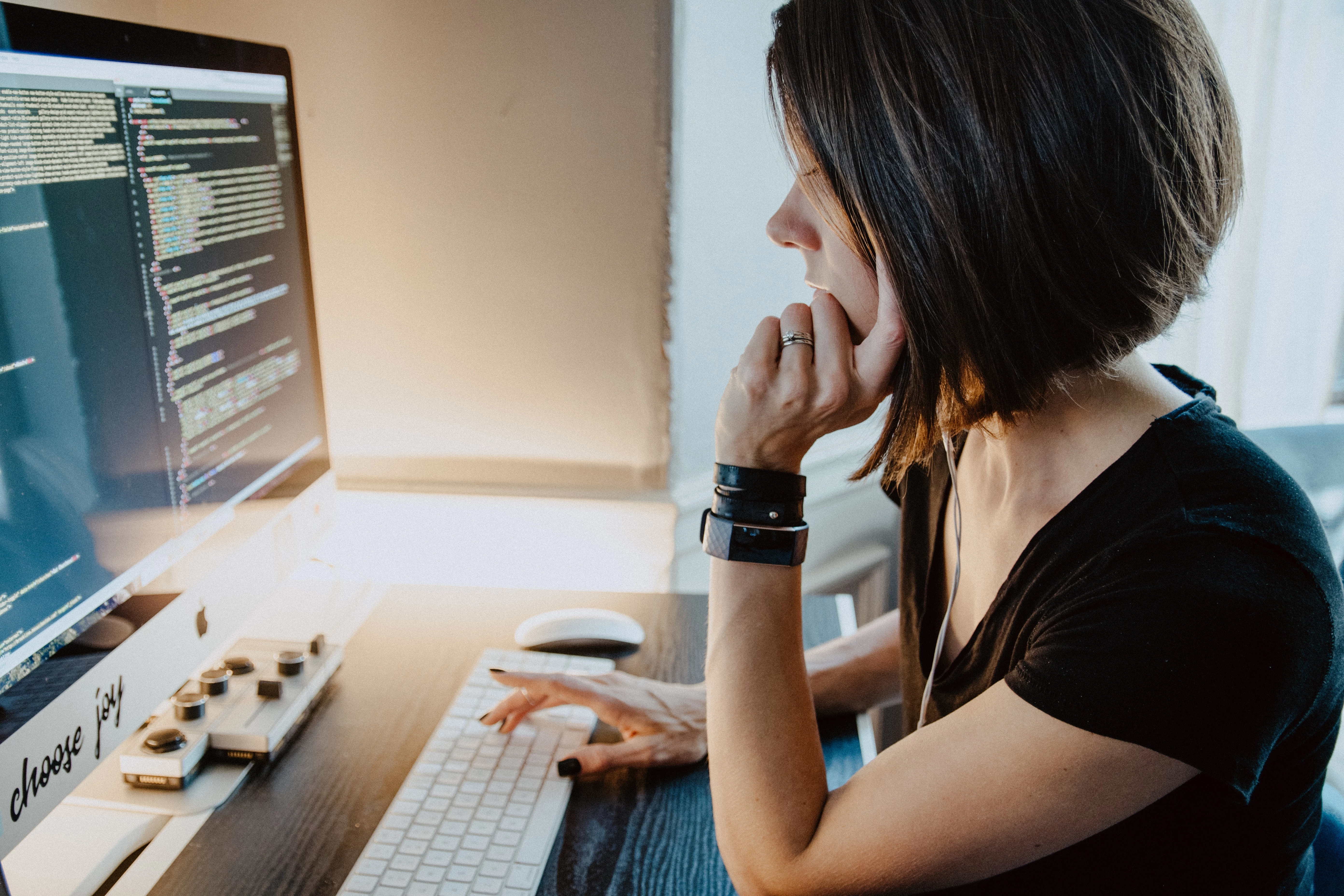 Woman looking at website code on desktop