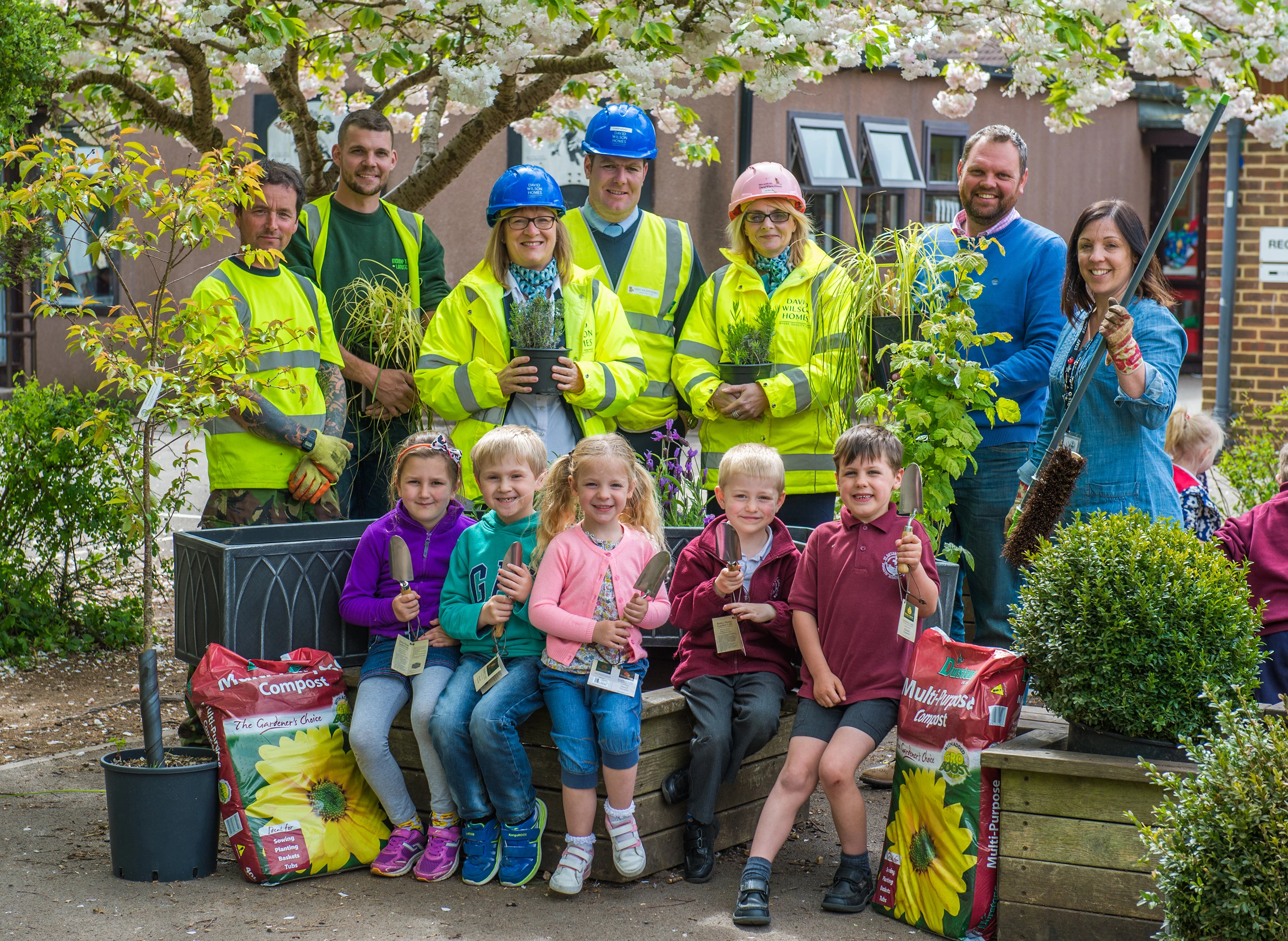 St Cuthbert’s Infants School pupils with head teacher Naomi Philip, a parent and staff from David Wilson Homes and Durstens