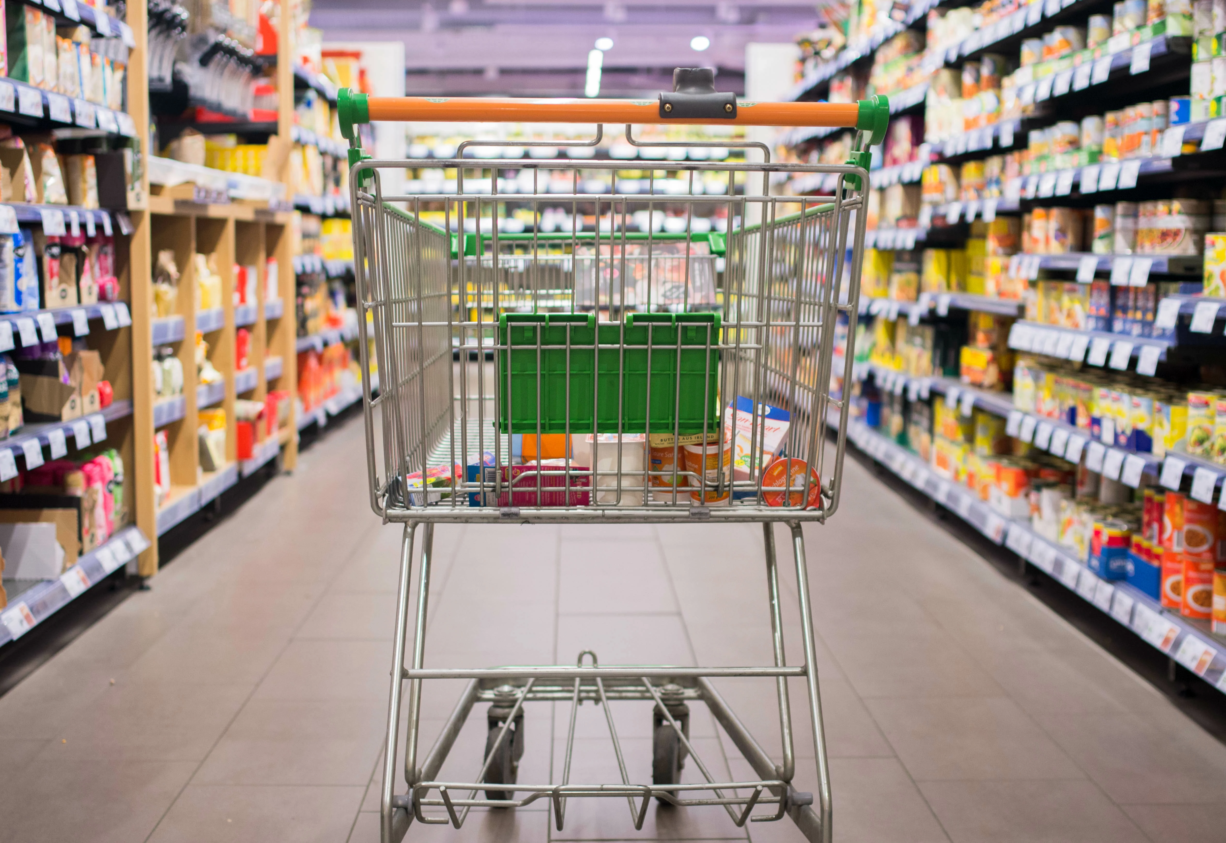 Shopping cart moving through isle of market