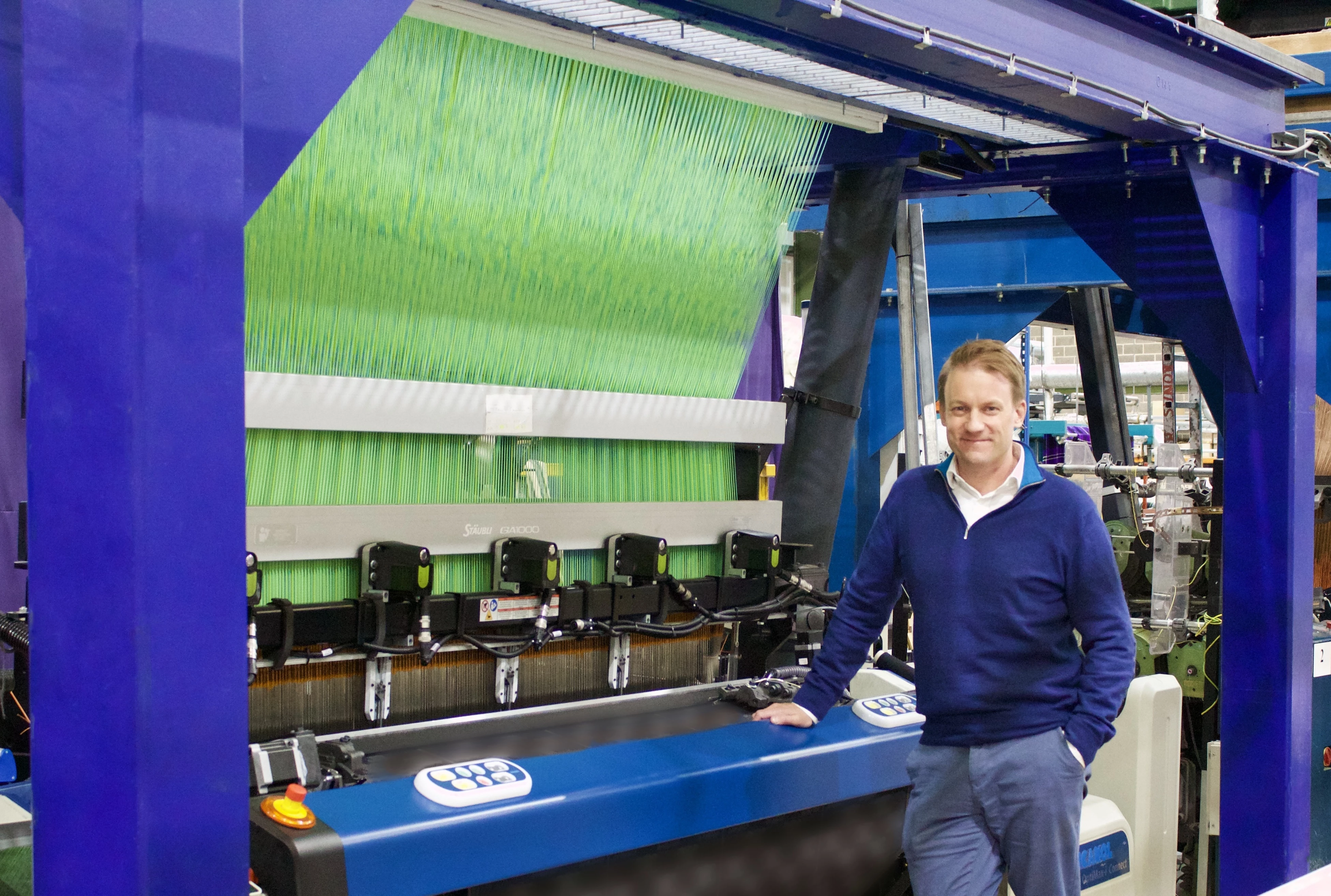 Joshua Ellis' Managing Director Oliver Platts stood by the company's new loom.