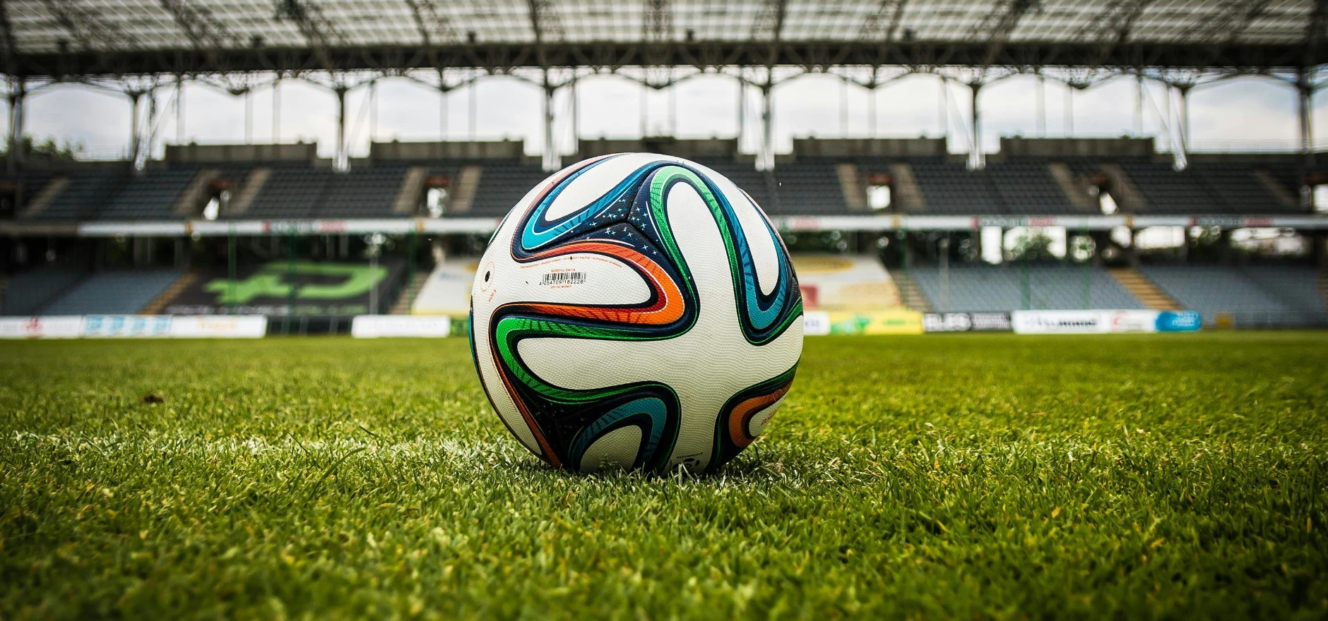 Multicolored Soccer Ball on Green Field