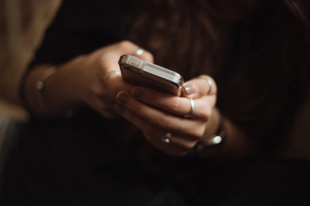 Person holding mobile phone