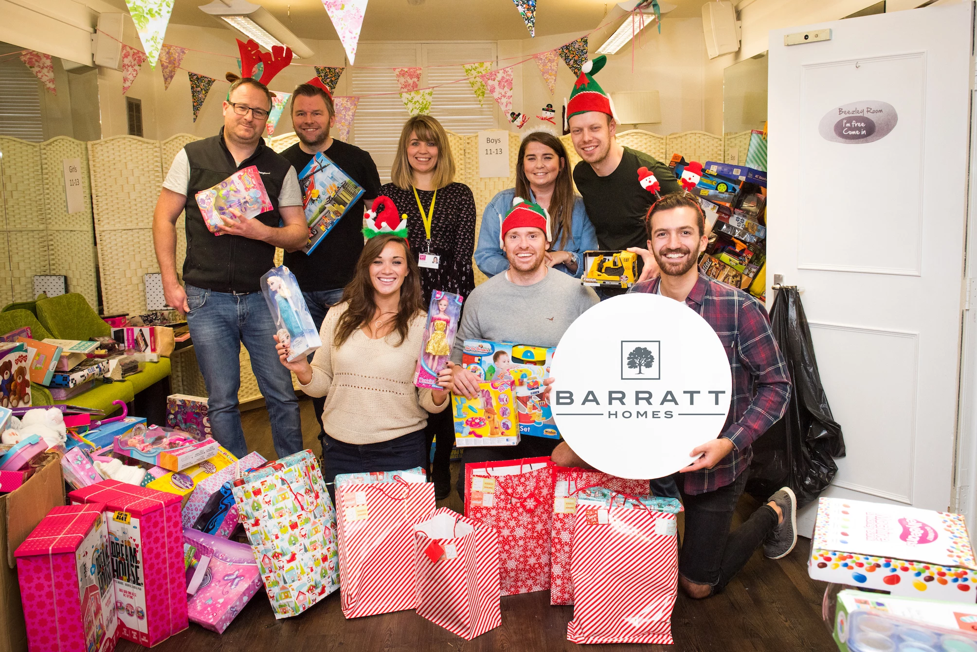 Barratt Developments Yorkshire West's team of Christmas elves donate a day to help Candlelighters wrap presents for its children's party