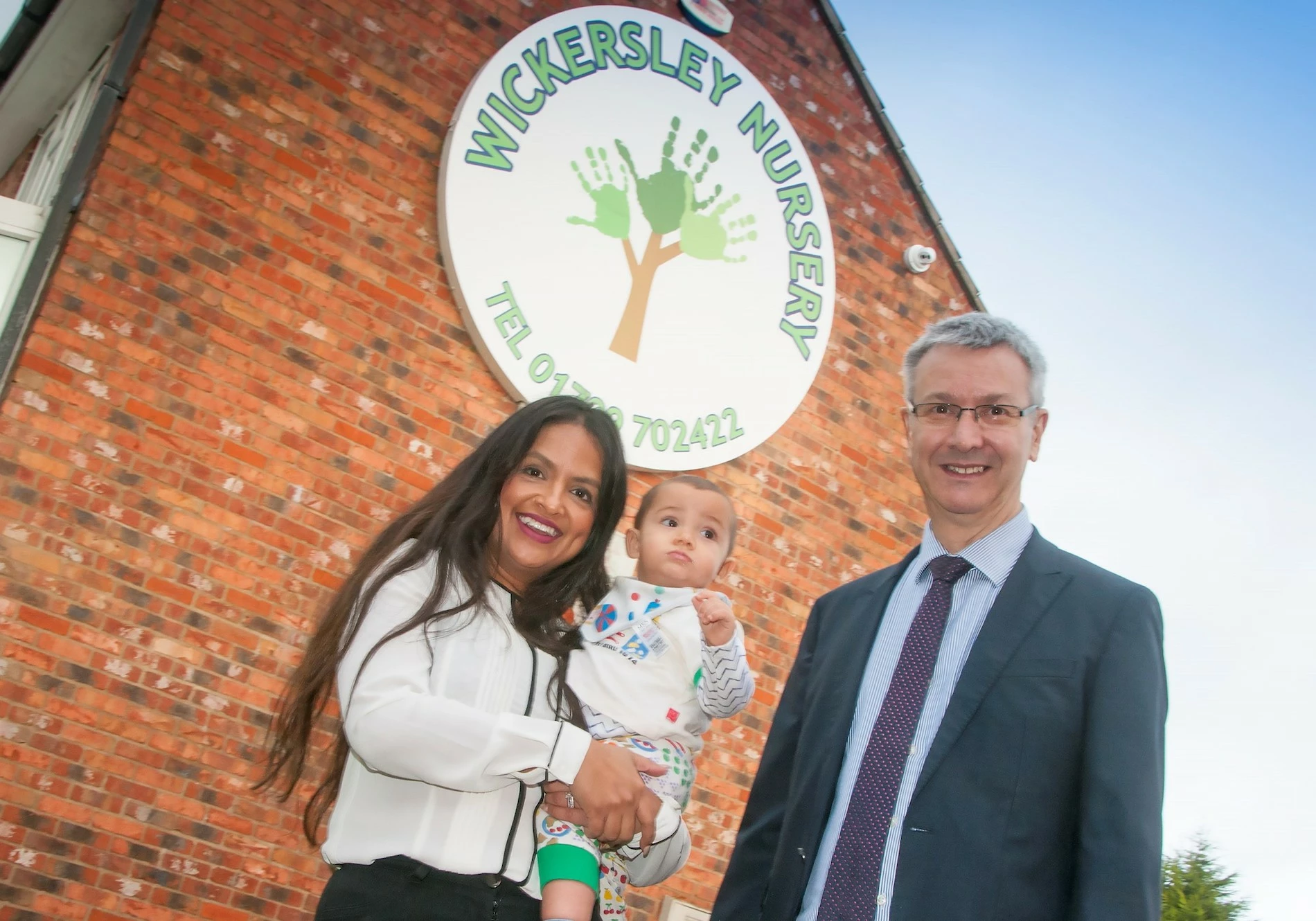 Wickersley Nursery (l to r) Dr Sipra Deb, her son Krishna and Julian Rowden of Lupton Fawcett, exterior.