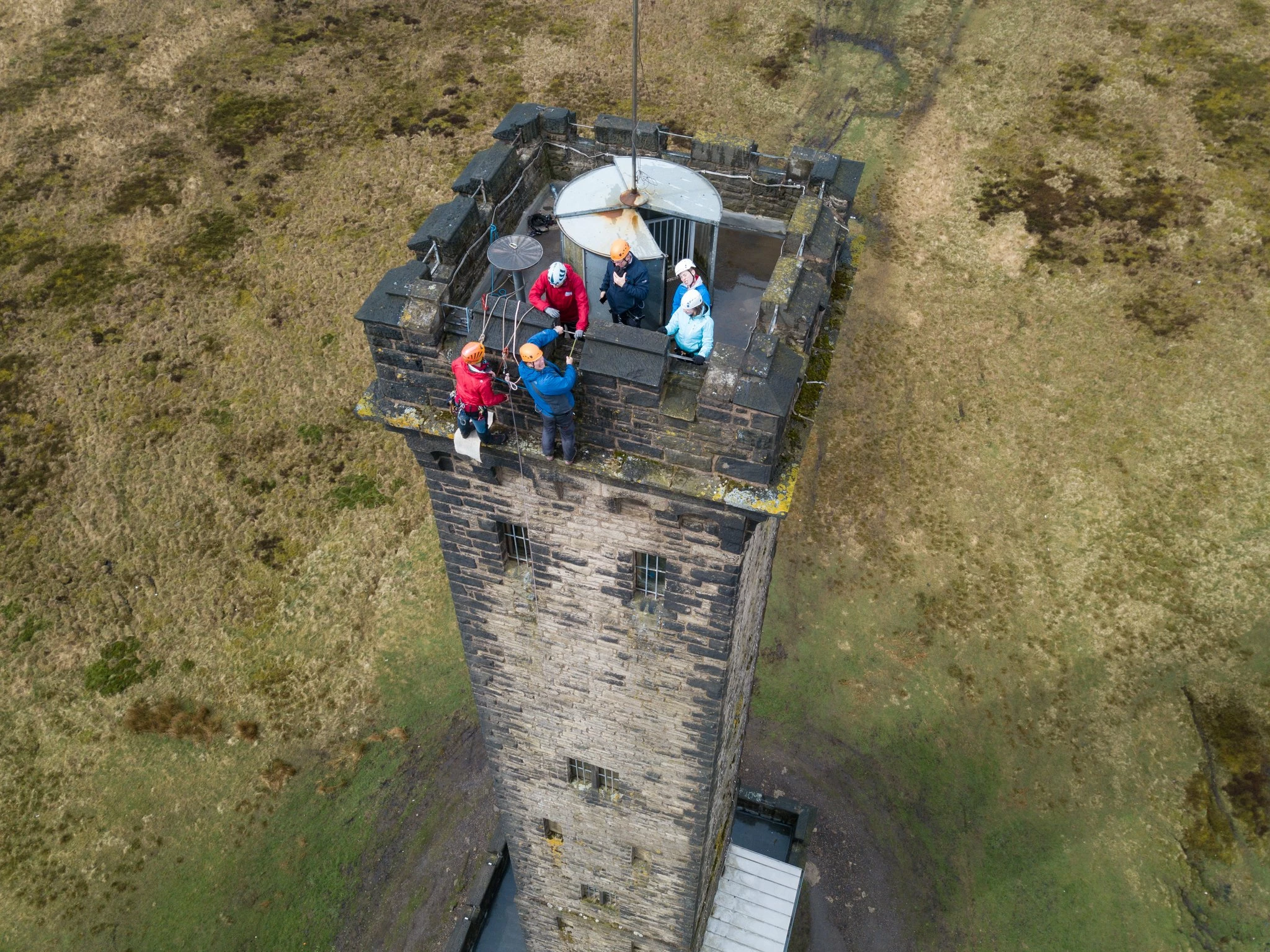 Conlon Construction members of staff abseiling down Peel Tower