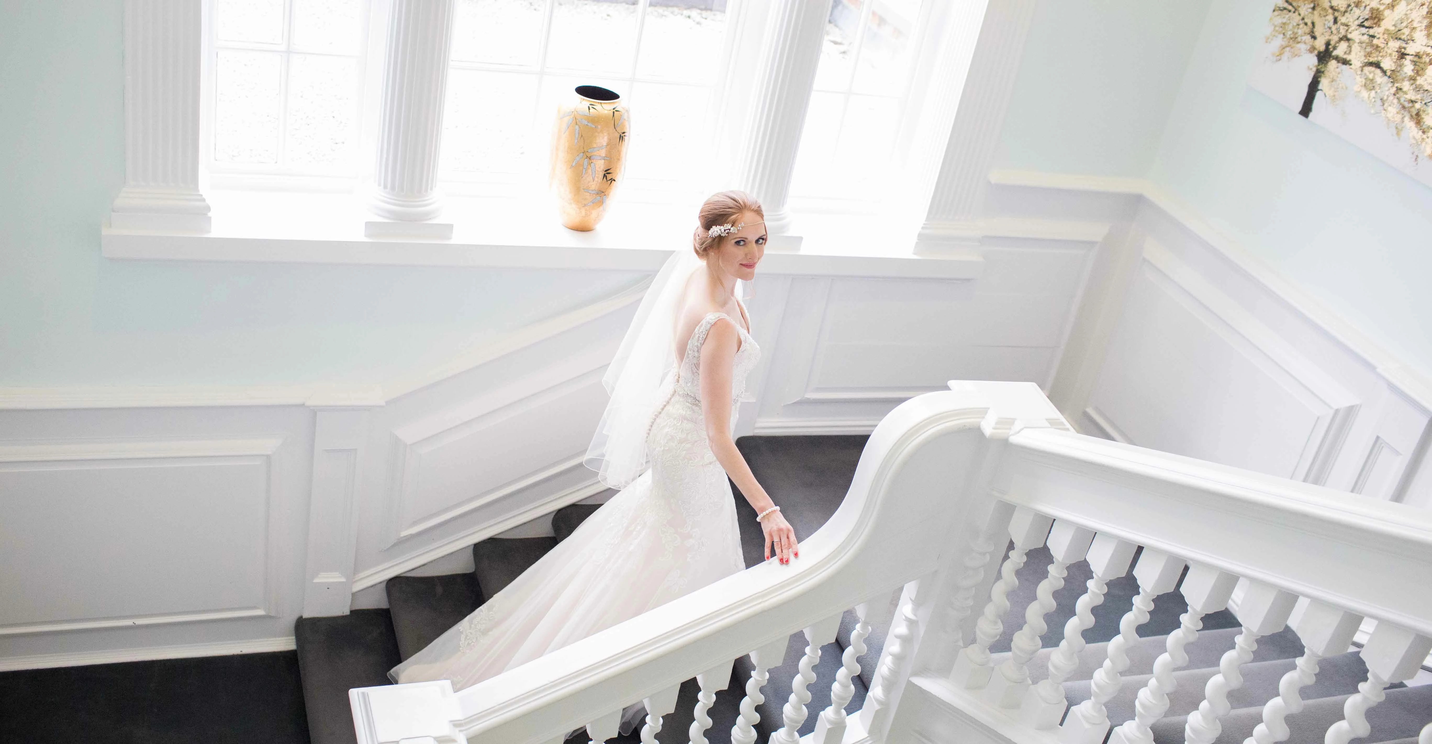 A bride on the grand staircase in the Manor House, Sedgefield