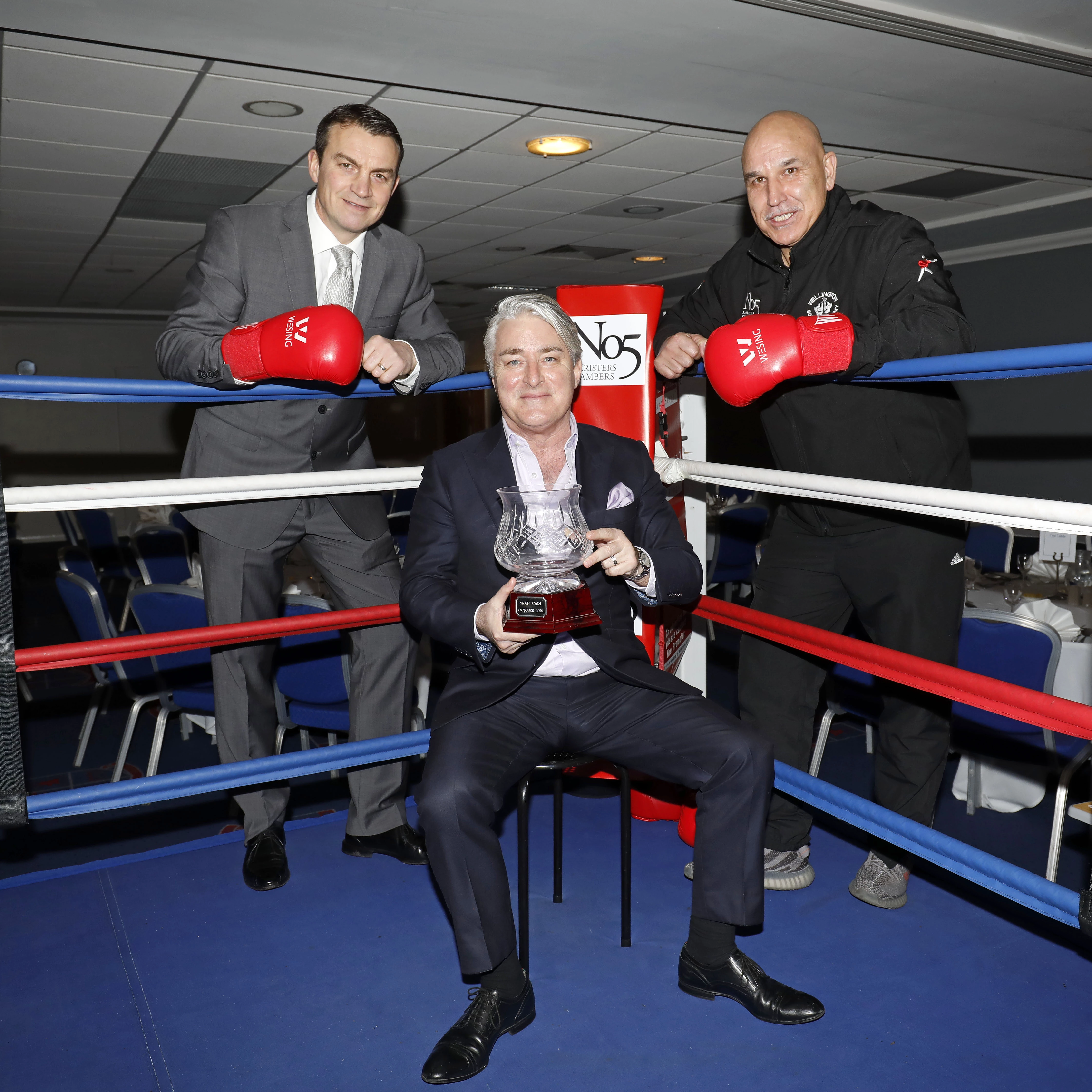 Pictured, from left, former WBC super-middleweight champion Richie Woodhall, Tony McDaid, CEO and Director of Clerking at No5 Barristers’ Chambers, holding the Len Woodhall Memorial Trophy and Wellington Boxing Academy head coach Mo Fiaz	