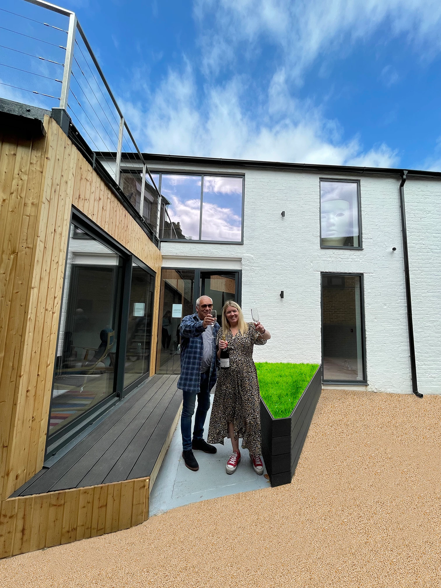 and Polly Sowden, father-daughter duo, in front of their first completely custom-designed office 